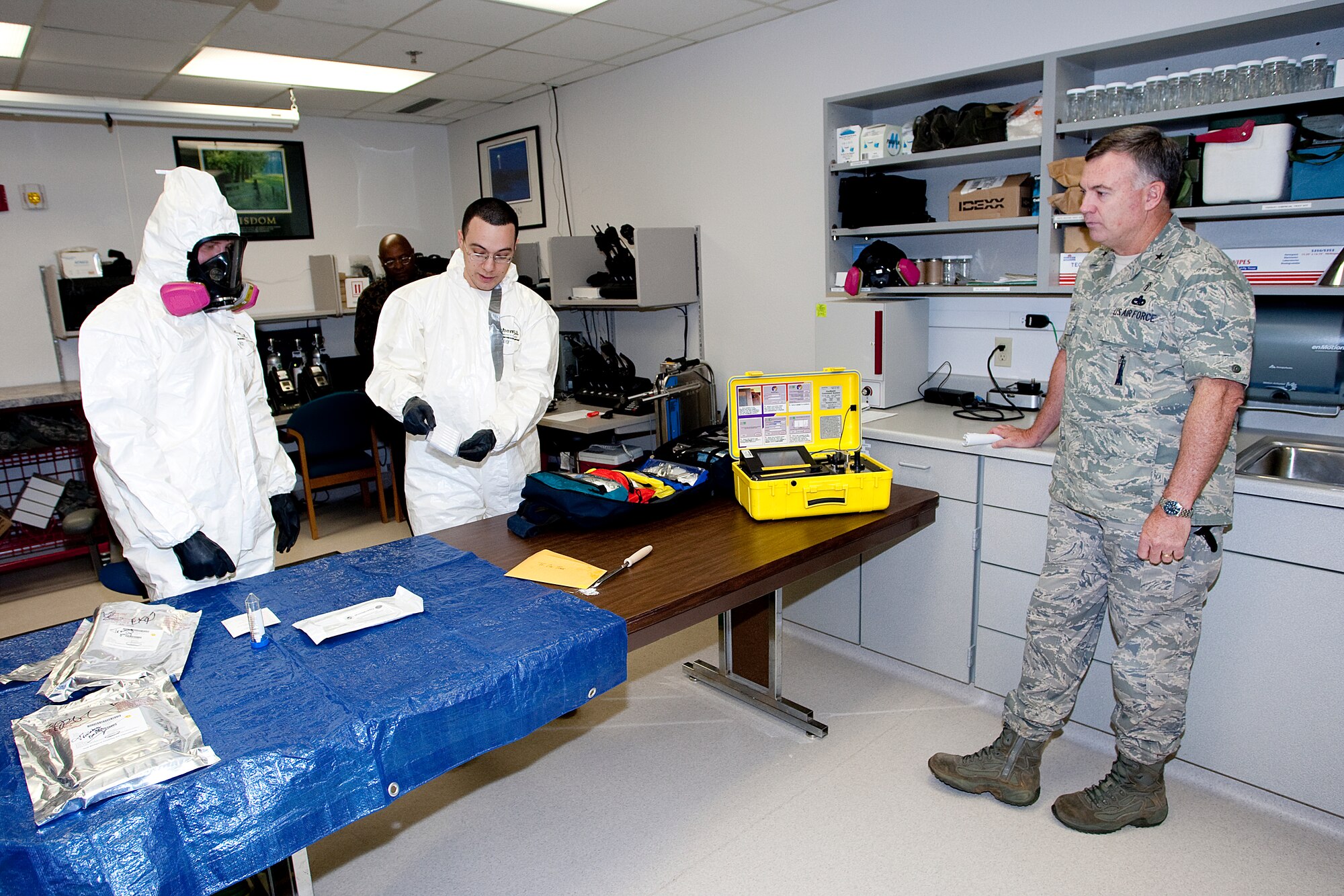 Brig. Gen. James Carroll, Assistant Surgeon General, Modernization and Biomedical Sciences Corps. Chief, observes Senior Airman Daniel Rivera and Airman 1st Class Blake Everhart, both from the 90th Medical Operations Squadron, as they give an equipment demonstration in the medical center here June 16. (U.S. Air Force photo by Matt Bilden)