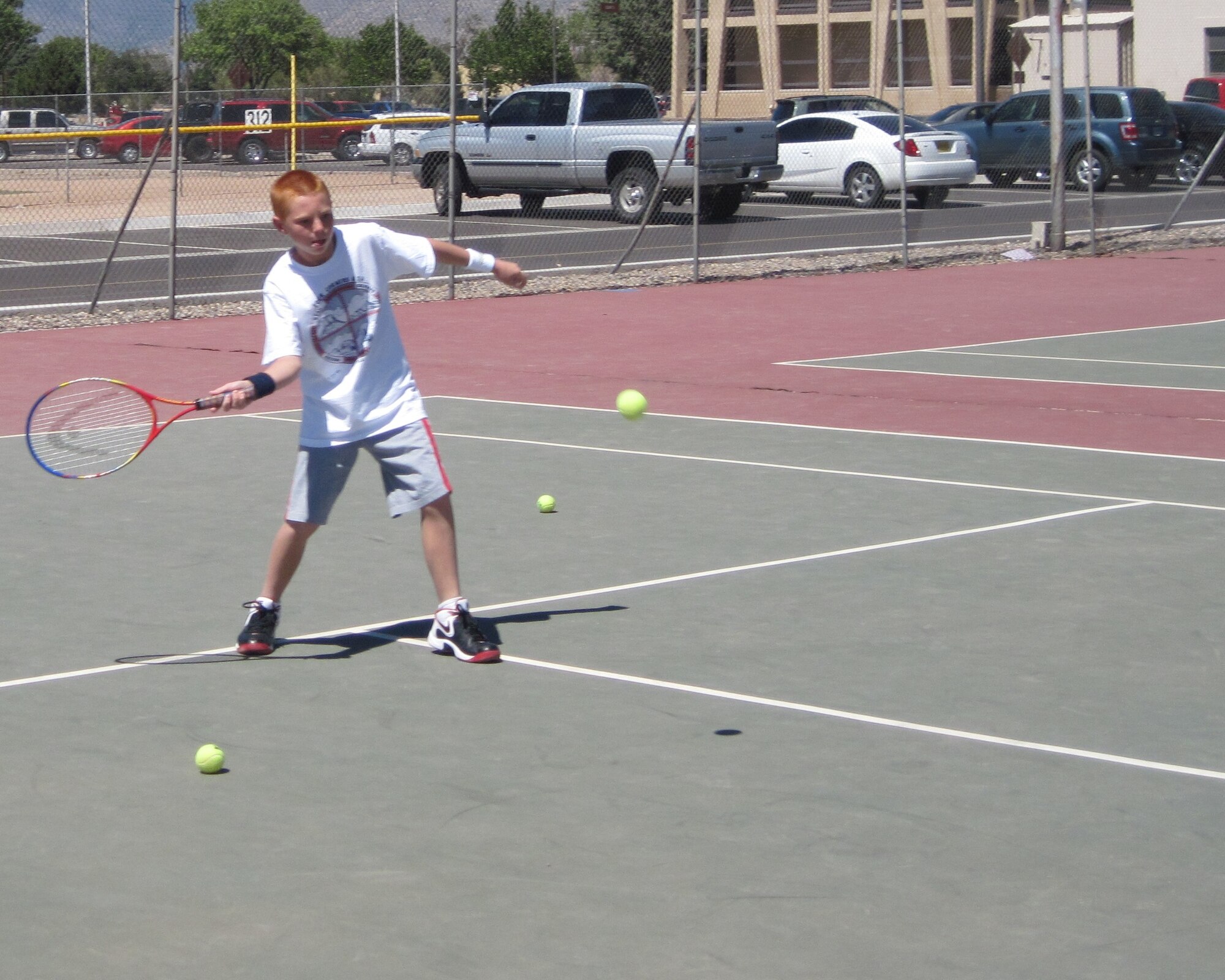 Kirtland Air Force Base, N.M. -- Ben Webster practices returning a serve June 22 during a tennis camp hosted by the Youth Center here. (Air Force photo by Jonathan Rejent.) 