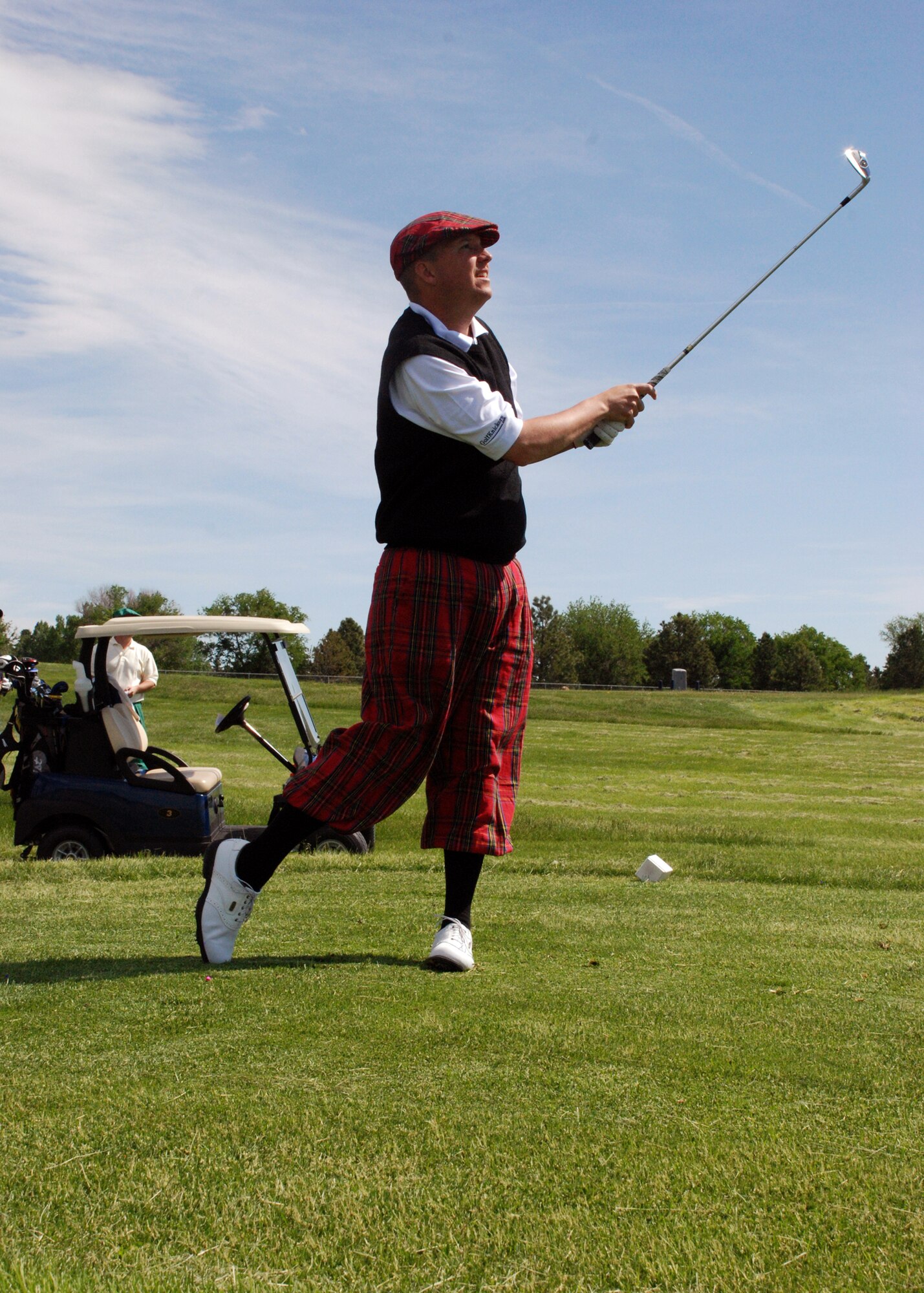 Tech. Sgt. Bryan Broberg, 90th Security Support Squadron Armory NCO-in-charge, follows through on his shot during a golf tournament here June 17. The 76 people who participated in the tournament raised more than $4,000 to benefit the Children's Hospital Colorado in Denver. (U.S. Air Force photo by Torri Ingalsbe)