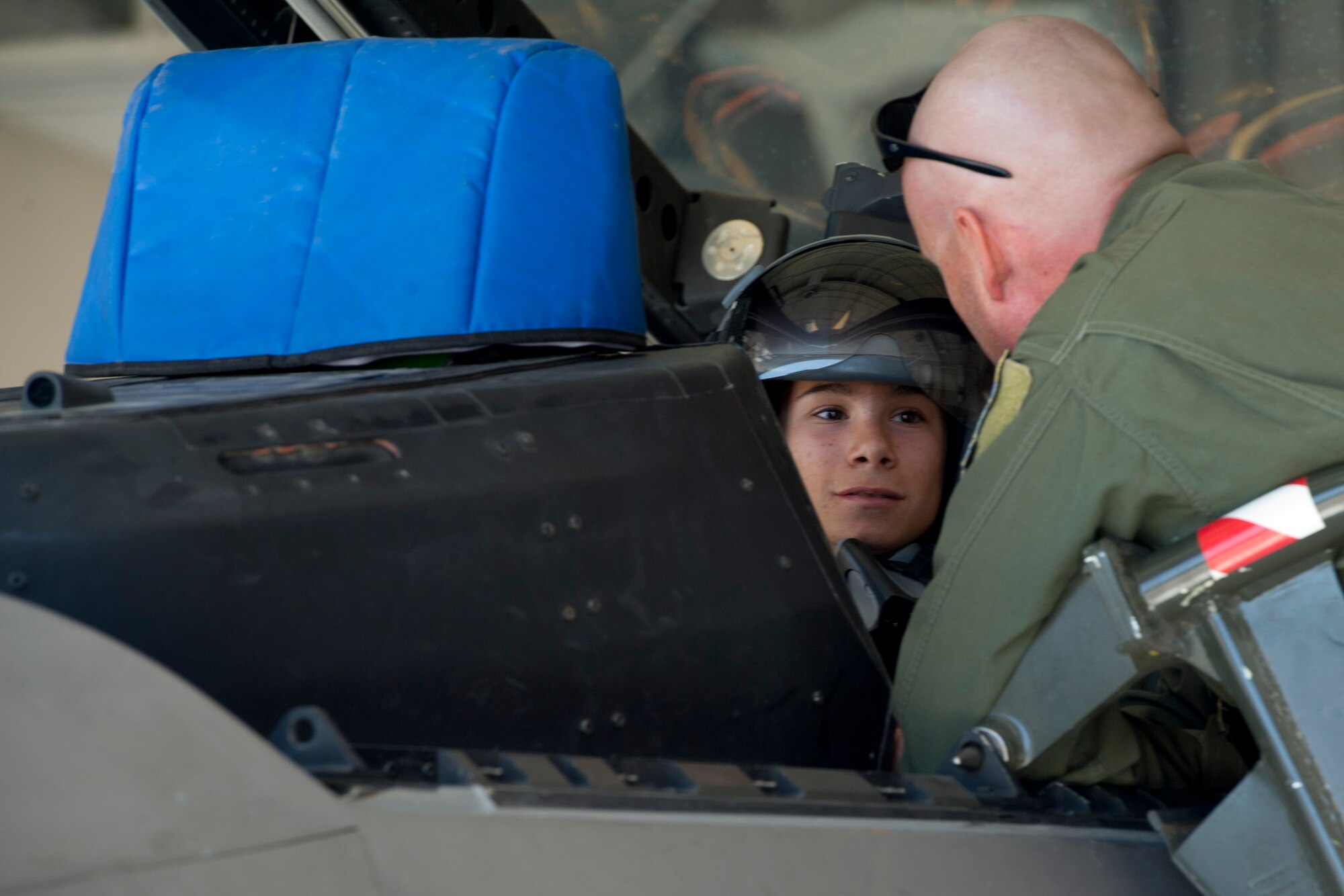 HOLLOMAN AIR FORCE BASE, N.M. -- A.J. Harrison, 16, who has spina bifida, is briefed, June 21, 2011, by Lt. Col. Robert Buchanan, 301st Fighter Squadron, about the capabilities of the F-22 Raptor. As part of the 301st FS fighter pilot for a day, A.J. was given a mission brief and was able to see the aircraft from a pilot’s point of view. (U.S. Air Force photo by Airman 1st Class Joshua Turner/Released)