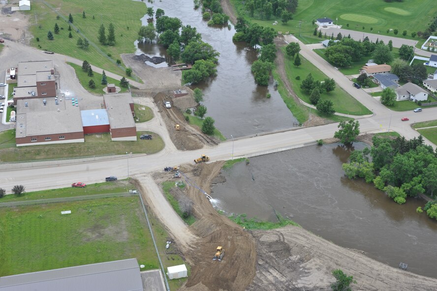 MINOT AIR FORCE BASE, N.D. -- Many residents of Minot and surrounding communities began to feel the effects of the flood here, Jun.22.  By noon, the river crested over the levees and the warning sirens sounded requiring the immediate evacuation of more than 11,000 Minot residents.  On June 27, 2011, Mouse River pressures and heights will reach unprecedented levels—seven to ten feet higher than the all time record with pressures reaching approximately 16,000 cubic feet per second. (U.S. Air Force photo/Staff Sgt. Keith Ballard)