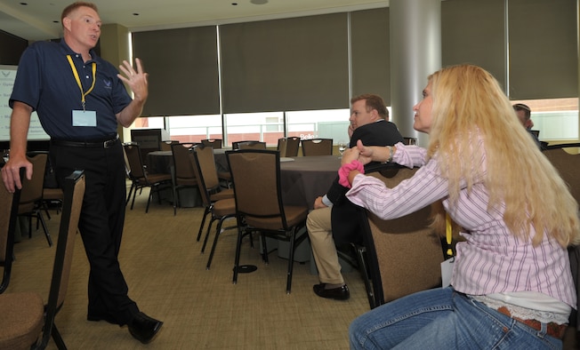 Lt. Col. Carl Supplee, left, a Reserve chaplain with the 446th Airlift Wing at Joint Base Lewis McCord, Wash., talks to deployers and their families about resilience during the western region Yellow Ribbon event at the Westin Hotel in Bellevue, Wash., June 11-12. Chaplain Supplee was one of three Reserve chaplains on hand to provide spiritual counseling and resilience training at the event. (U.S. Air Force photo by Tech. Sgt. Scott P. Farley)