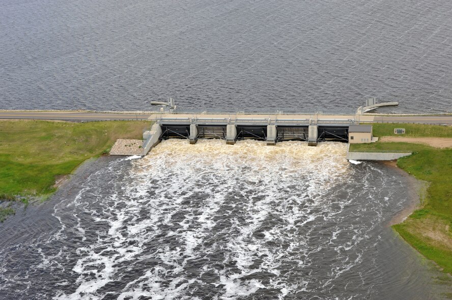 MINOT AIR FORCE BASE, N.D. -- Many residents of Minot and surrounding communities began to feel the effects of the flood here, Jun.22.  By noon, the river crested over the levees and the warning sirens sounded requiring the immediate evacuation of more than 11,000 Minot residents.  On June 27, 2011, Mouse River pressures and heights will reach unprecedented levels—seven to ten feet higher than the all time record with pressures reaching approximately 16,000 cubic feet per second. (U.S. Air Force photo/Staff Sgt. Keith Ballard)