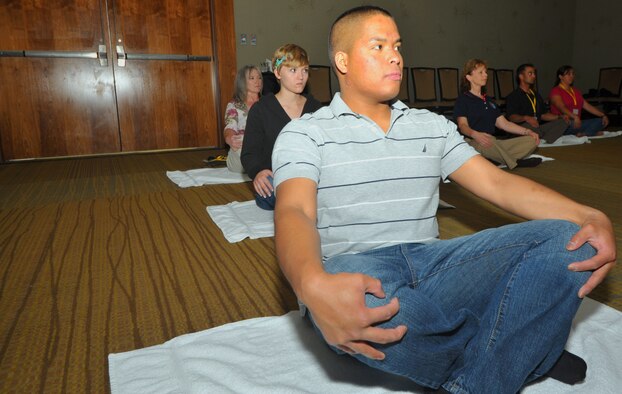 Senior Airman Calvin Pangelinan, a Reservist from Joint Base Lewis McCord, Wash., practiced stress management with yoga during a breakout session at the western region Yellow Ribbon event at the Westin Hotel in Bellevue, Wash., June 11-12. Two breakout sessions for stress management and relaxation through yoga were held during the event. (U.S. Air Force photo by Tech. Sgt. Scott P. Farley)