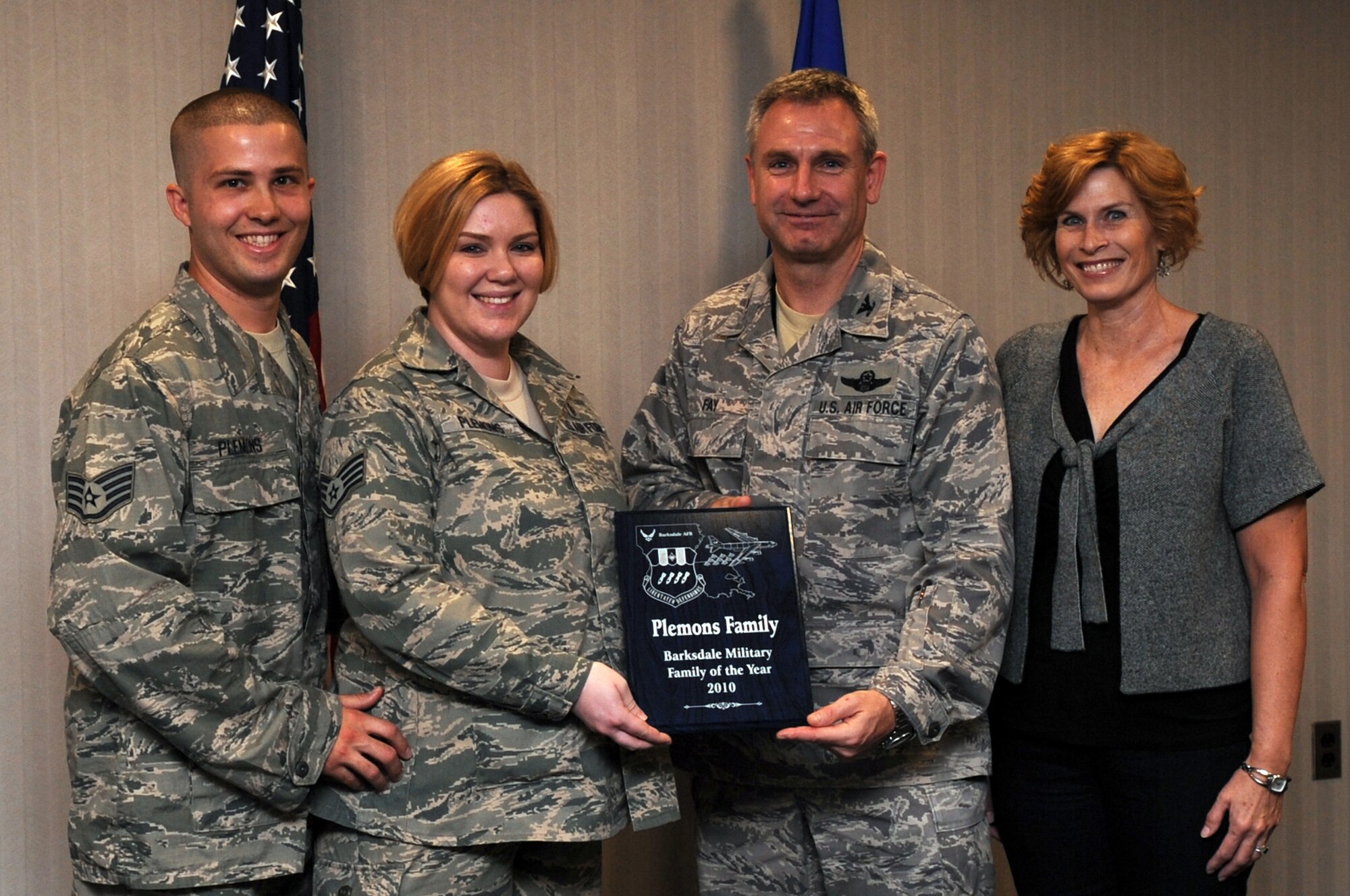 Col. Tim Fay, 2nd Bomb Wing commander, and his wife Kathleen, present the first Barksdale Military Family of the Year award to Staff Sgt. Brian Plemons, 2nd Civil Engineer Squadron, and Staff Sgt. Samantha Plemons, 2nd Aerospace Medicine Squadron, at Barksdale Air Force Base, La., Nov. 24, 2010. (U.S. Air Force photo/Senior Airman La?Shanette Garrett)