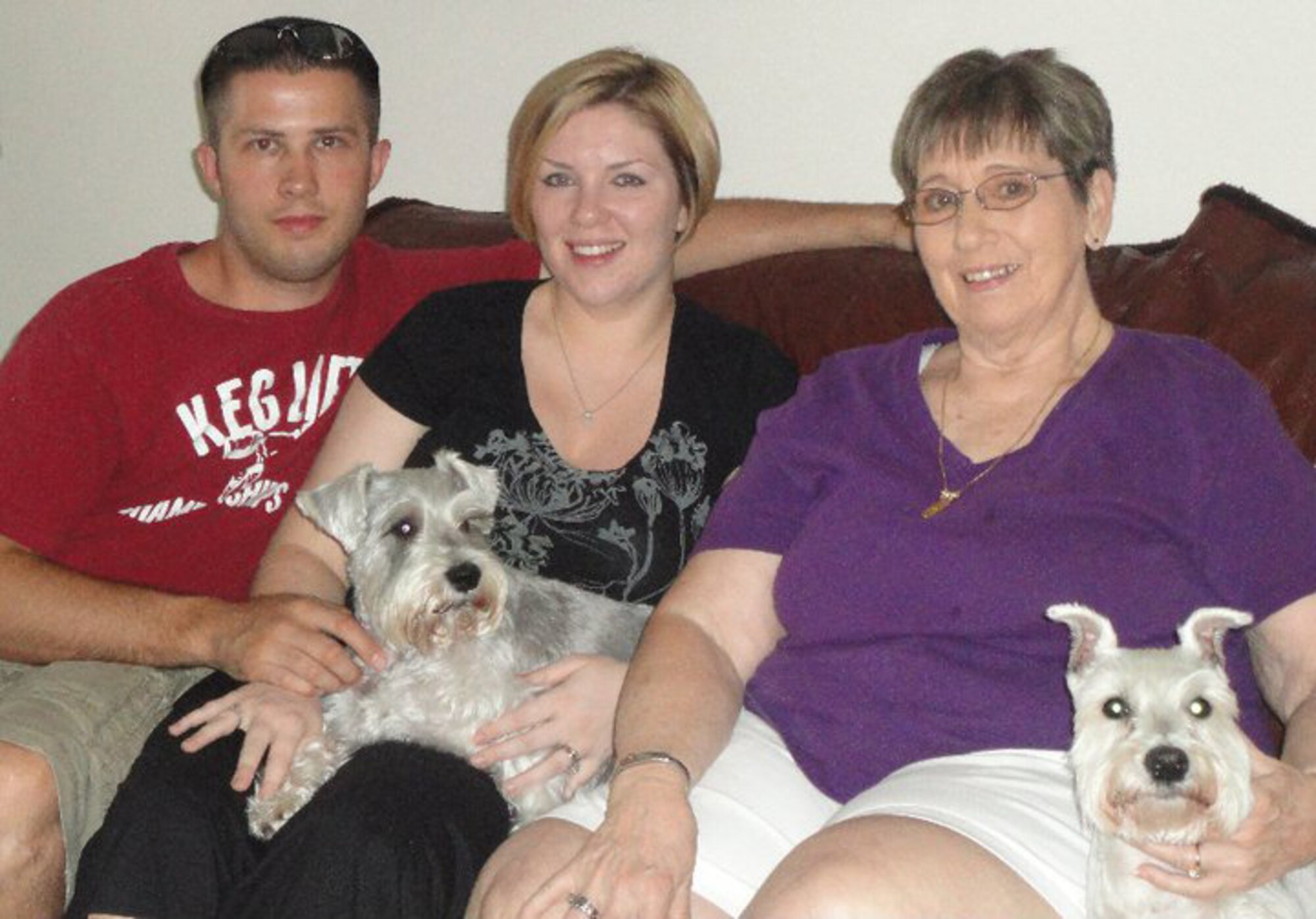 Staff Sgt. Brian Plemons, 2nd Civil Engineer Squadron, and Staff Sgt. Samantha Plemons, 2nd Aerospace Medicine Squadron, pose for a photo with their grandmother Patricia Bradley and their dogs Lucy and Mysti in Titusville, Fla. (Courtesy photo)