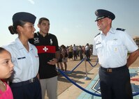 Col. Shane Courville, Air Force Basic Military Training commander, talks with Airman Kiara Cruz, 326th Training Squadron, Flight 422, after BMT graduation June 17. After two years as the 737th Training Group commander, Colonel Courville will relinquish command during a ceremony July 1. (U.S. Air Force photo/Robbin Cresswell)