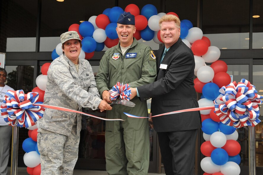 SEYMOUR JOHNSON AIR FORCE BASE, N.C.- Colonels Anne Winkler and Patrick Doherty, and Dave Dingwell (left to right) cut the ribbon for the ribbon cutting ceremony to celebrate the Exchange grand re-opening here, June 23, 2011. The Exchange held a grand re-opening showcase overall improvements to the store. Colonel Doherty is the 4th Fighter Wing commander, Colonel Winkler is the 4th Mission Support Group commander, and Mr. Dingwell is the Exchange general manager. (U.S. Air Force photo by Senior Airman Whitney Lambert/Released) 