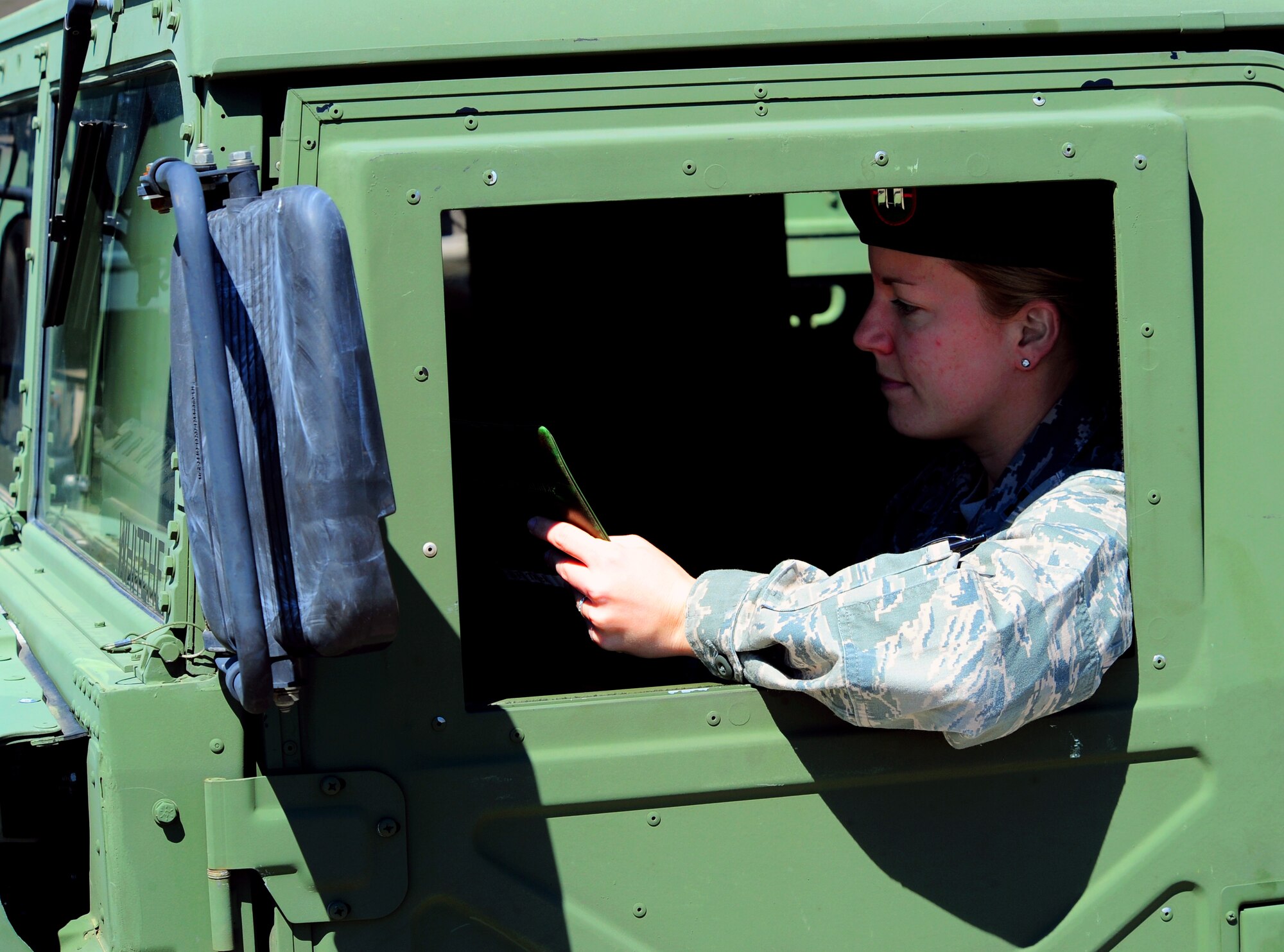 Capt. Sarah Eccles sits in a HUMVEE and checks a map April 5, 2011.  Captain Eccles, an F-16 Fighting Falcon pilot, currently is serving in a career-broadening assignment as an air liaison officer in the 682nd Air Support Operations Squadron at Shaw Air Force Base, S.C.  (U.S. Air Force photo/Airman 1st Class Daniel Phelps)