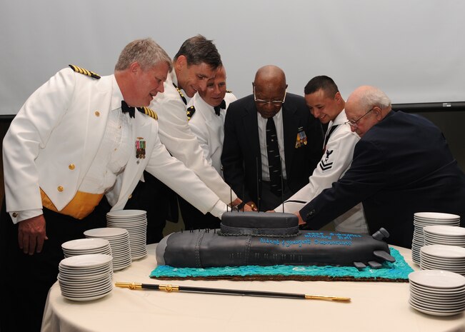 Charleston area submariners recently celebrated 111 years of service at the Submarine Ball June 18 at Trident Technical College's banquet facility. Cutting the ceremonial cake (left to right) are Capt. Tom Bailey, Capt. Ralph Ward, Cmdr. Mark Schmitt, World War II veteran William Jones, Yeoman Second Class Flores and WOrld War II veteran Stacy Powers. Captain Bailey is the Naval Nuclear Power Training Command commanding officer, Captain Ward is the Joint Base Charleston deputy commander and Commander Schmitt is the director of Nuclear Field "A" school. YN2 Flores was the youngest submarine qualified member in attendance. 