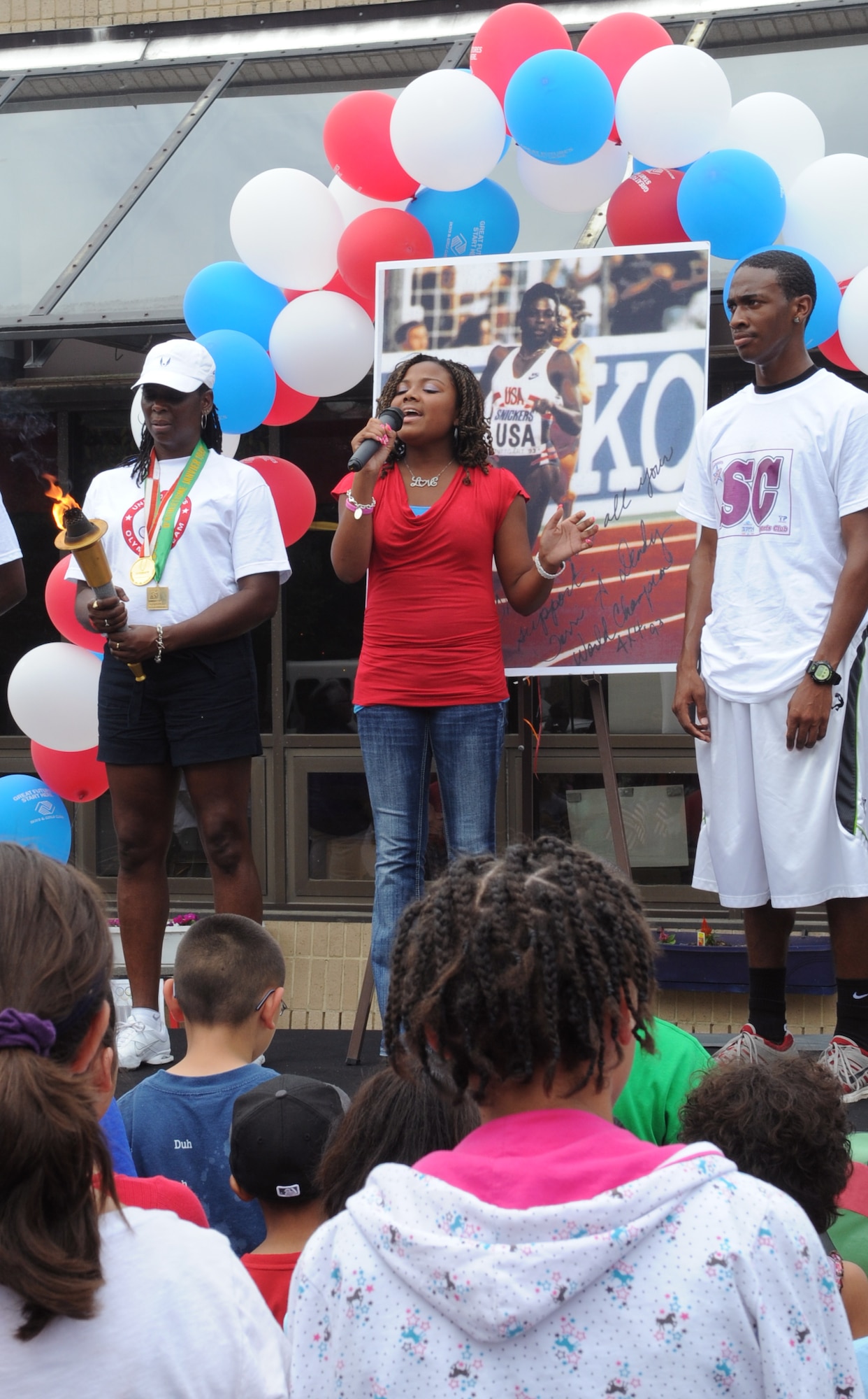 Bria Parker sings the National Anthem during the opening ceremony at the Andrews Youth Center Olympic Day celebration June 22.  Terri Dendy, a former olympian, was the guest of honor. (U.S. Air Force photo by Senior Airman Torey Griffith)