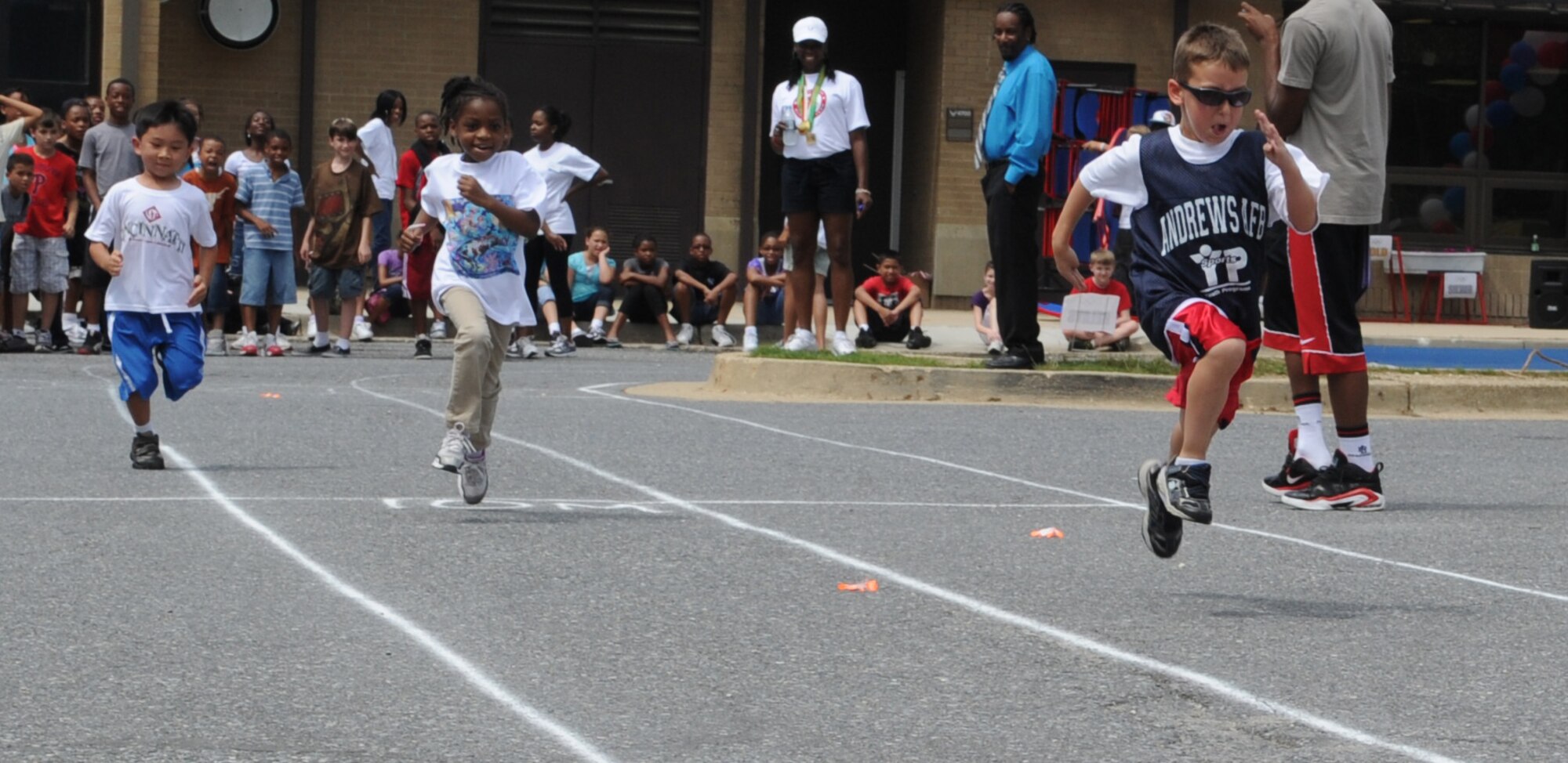 Children from the Andrews Youth Center compete in the 10 meter dash at the Olympic Day celebration June 22.  Former Olympian, Terri Dendy, was the guest of honor.
