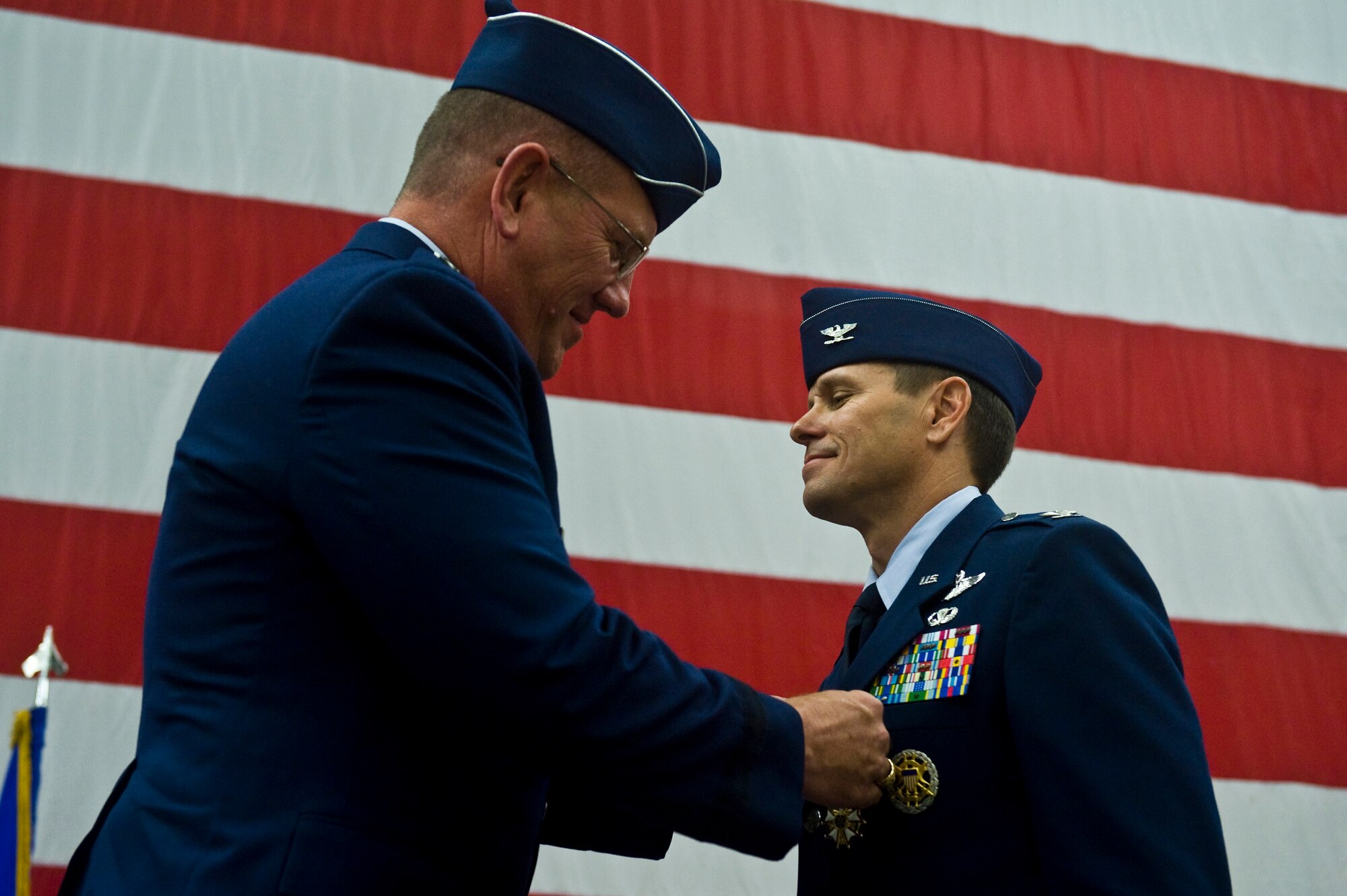 Maj. Gen. Bill Hyatt, U.S. Air Force Warfare Center commander, presents the Legion of Merit to Col. John Montgomery, 98th Range Wing commander, at Nellis Air Force Base, Nev., June 21, 2011. Colonel Montgomery had served as 98 RANW commander since July 8, 2009 and was recognized for his leadership in providing the nation's premier integrated tactics, testing, and training battlespace to U.S. Air Force, joint and coalition warfighters.  During his tenure, Colonel Montgomery led 1,000 active-duty, civilian and contact personnel who were responsible for an $87 million annual budget and electronic combat instrumentation valued in excess of $500 million. (U.S. Air Force photo by Senior Airman Brett Clashman/Released)