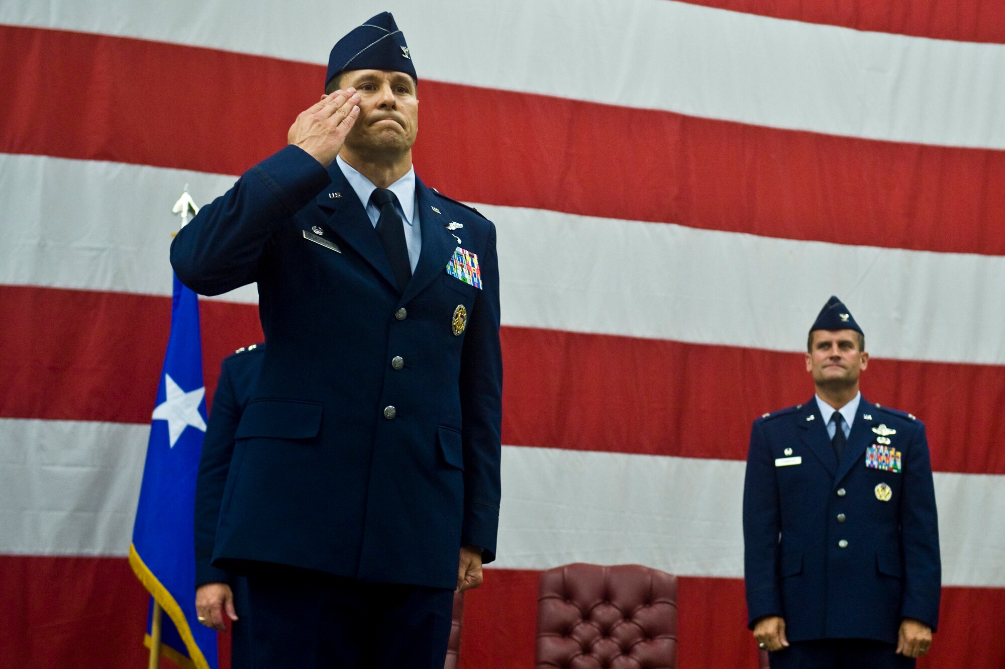 U.S. Air Force Col. John Montgomery, outgoing 98th Range Wing commander, renders a final salute to his wing at Nellis Air Force Base, Nev., June 21, 2011. During the event, the 98th Range Wing was officially re-designated the Nevada Test and Training Range and will remain a direct reporting unit to the U.S. Air Force Warfare Center. The NTTR will continue to operate, maintain and manage the 2.9-million-acre range (42 percent of the land managed by the U.S. Air Force) and 12,000 square miles of military airspace. More than 1,000 military, civilian and contract personnel are assigned to the organization. (U.S. Air Force photo by Senior Airman Brett Clashman/Released)