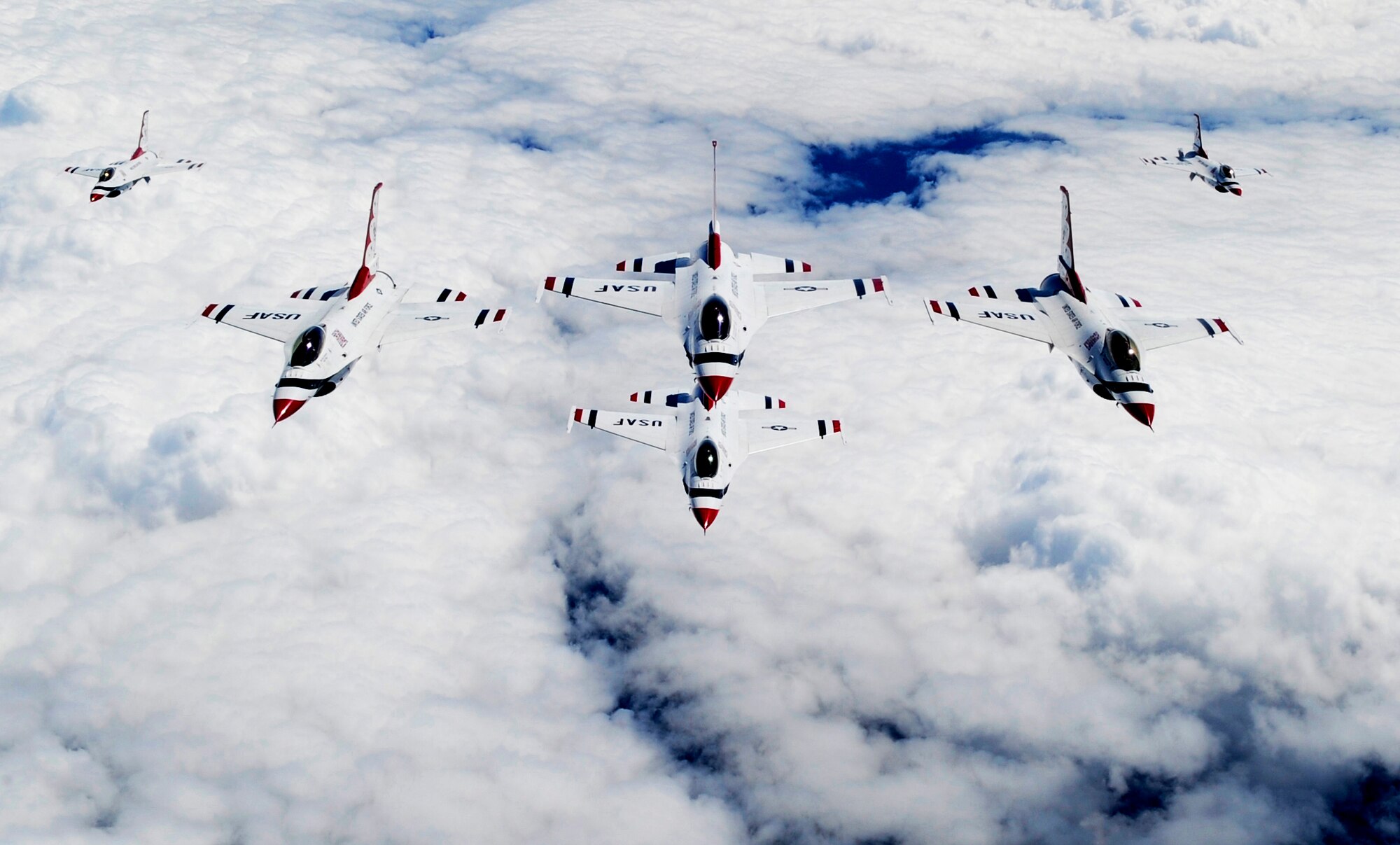 LATVIA, Northern Europe – The U.S Air Force Thunderbirds, F-16 Fighting Falcons, fly in formation behind a 100th Air Refueling Wing KC-135 Stratotanker after being refueled June 22, 2011. The Thunderbirds flew in one final formation to show their thanks for the support given to them by the 100th ARW during their air show performance in Latvia. (U.S. Air Force photo/Senior Airman Ethan Morgan)
