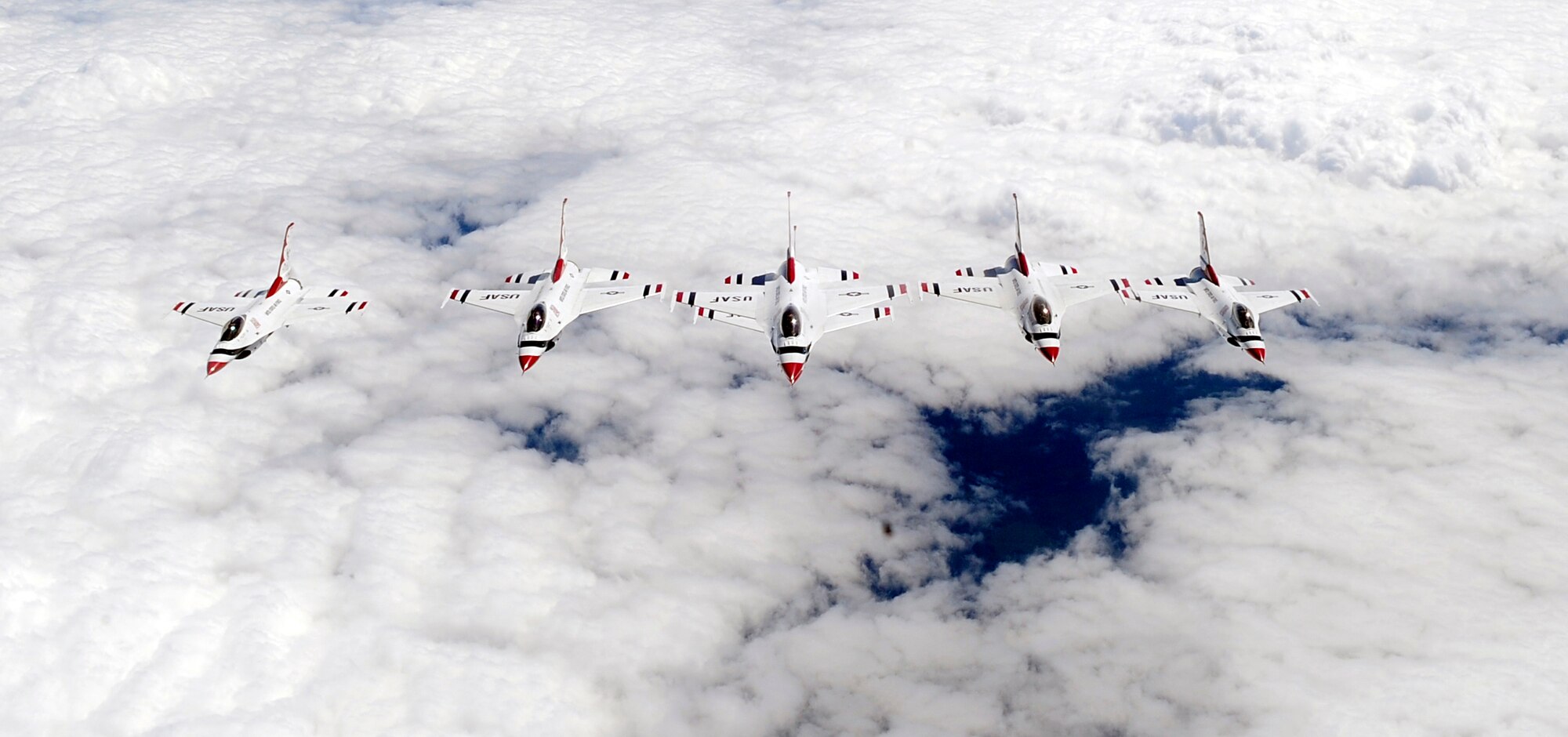 LATVIA, Northern Europe – The U.S Air Force Thunderbirds, F-16 Fighting Falcons, fly in formation behind a 100th Air Refueling Wing KC-135 Stratotanker after being refueled June 22, 2011. The Thunderbirds flew in their final formation after their air show performance in Latvia. (U.S. Air Force photo/Senior Airman Ethan Morgan)