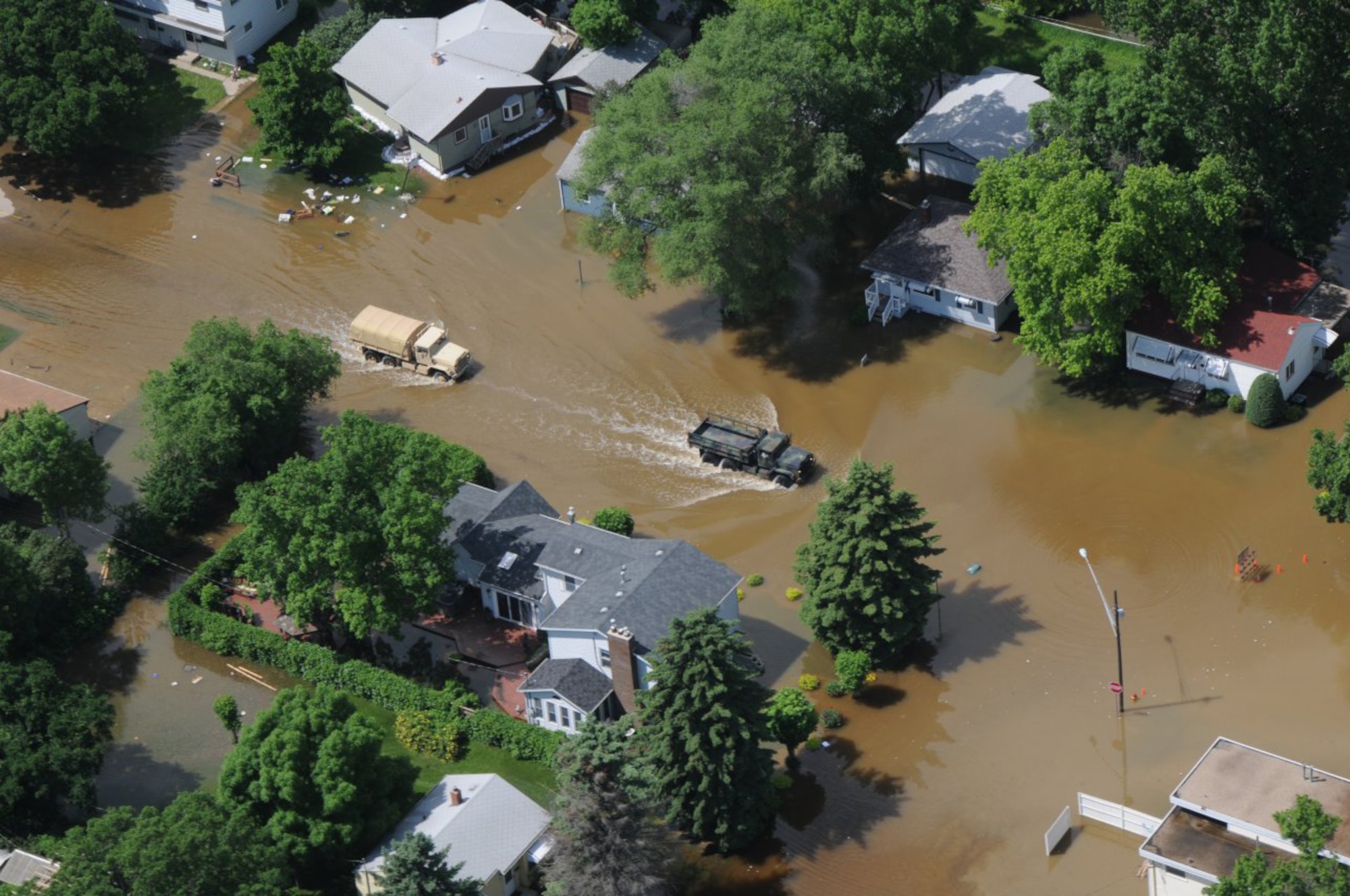 North Dakota National Guard vehicles patrol one of the mandatory evacuation zones in Minot, N.D. June 22, 2011, flooded by the rising water of the Souris River. The patrols ensure that all citizens have evacuated their homes and render any required assistance. (U.S. Air Force photo/Senior Master Sgt. David Lipp)