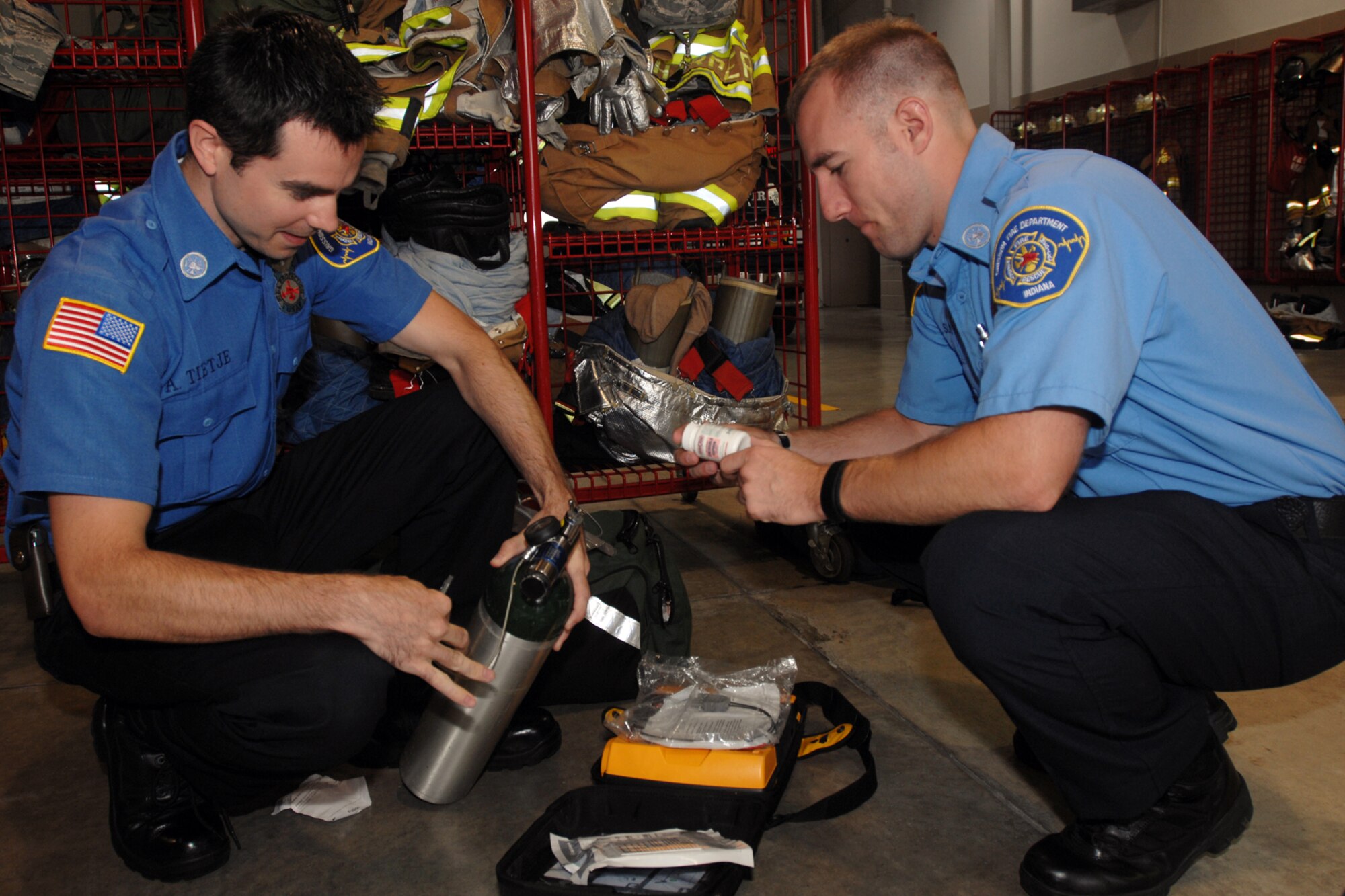 GRISSOM AIR RESERVE BASE, Ind., -- Aaron Tietje, left, and Aaron Sundheimer, emergency medical technicians with the Grissom Fire Department, perform an inspection on one their first responder kits. Grissom's first responders routinely travel outside the confines of the base to provide emergency treatment to those in need. (U.S. Air Force photo/Tech. Sgt. Doug Hays)