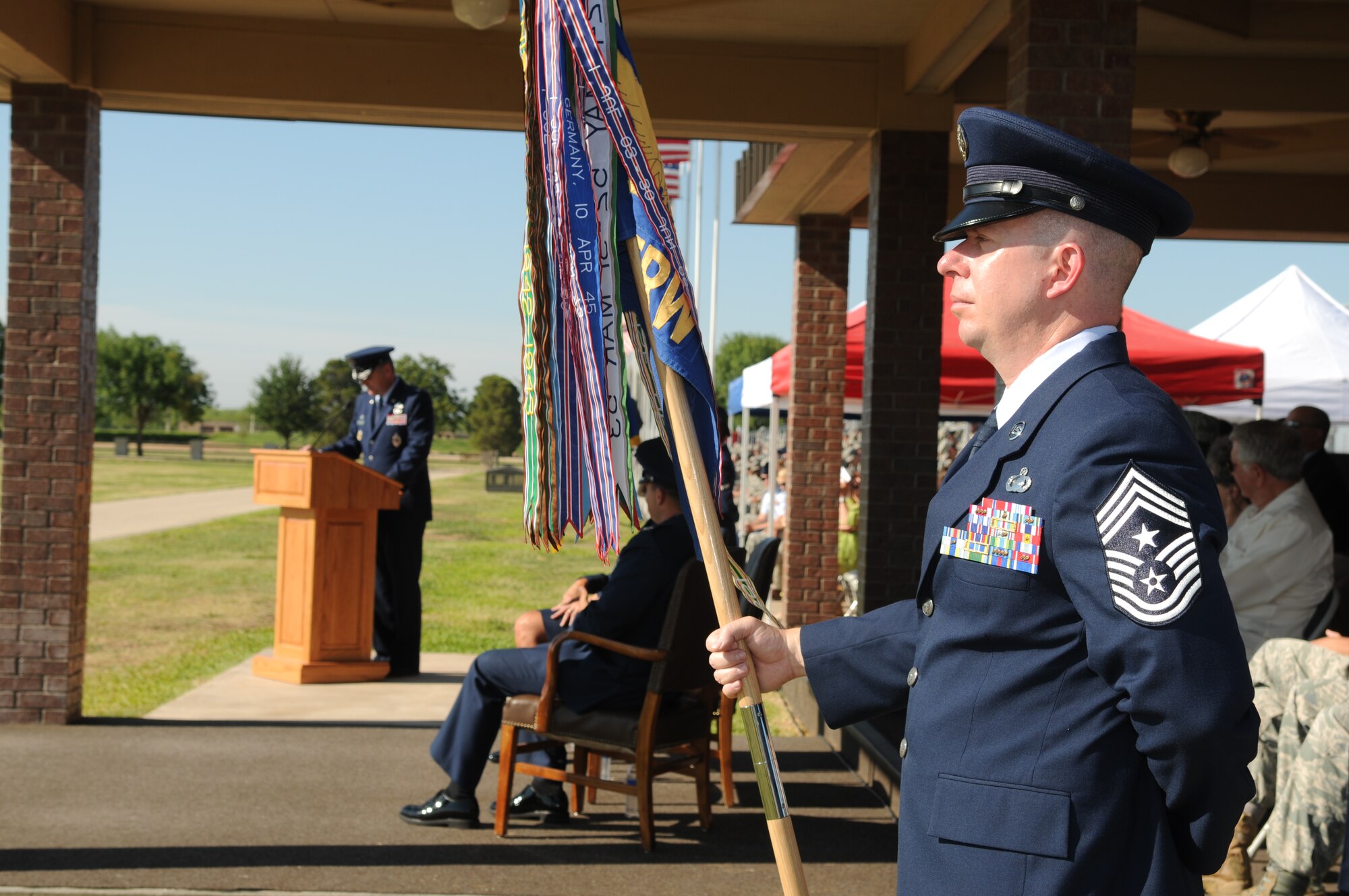 Chief Master Sgt. Brendan Criswell, 17th Training Wing Command Chief, holds the guidon as Col. Thomas Geary, former 17th TRW Commander addresses the audience during the Change of Command ceremony June 23. (U.S. Air Force photo/Staff Sgt. Heather L Rodgers)