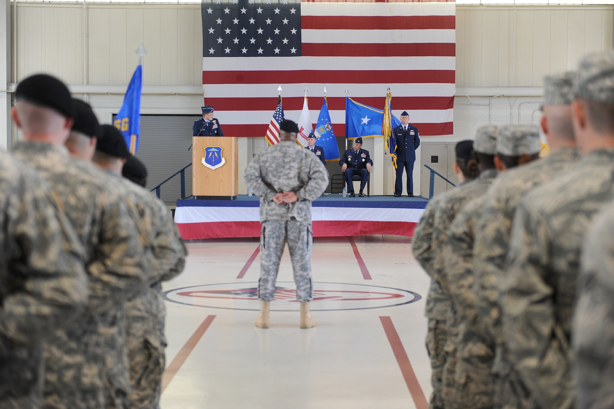 Soldiers and Airmen from the 633d Air Base Wing stand in formation during a change of command ceremony here Thursday. On stage from left to right, Maj. Gen. Stephen Hoog, 9th Air Force commander, Col. Korvin Auch, 633 ABW commander, and Col. Donald Kirkland, former 633 ABW commander, Chief Master Sgt. Kevin Howell, 633 ABW command chief. (U.S. Air Force photo by Staff Sgt. Antoinette Gibson/Released)
