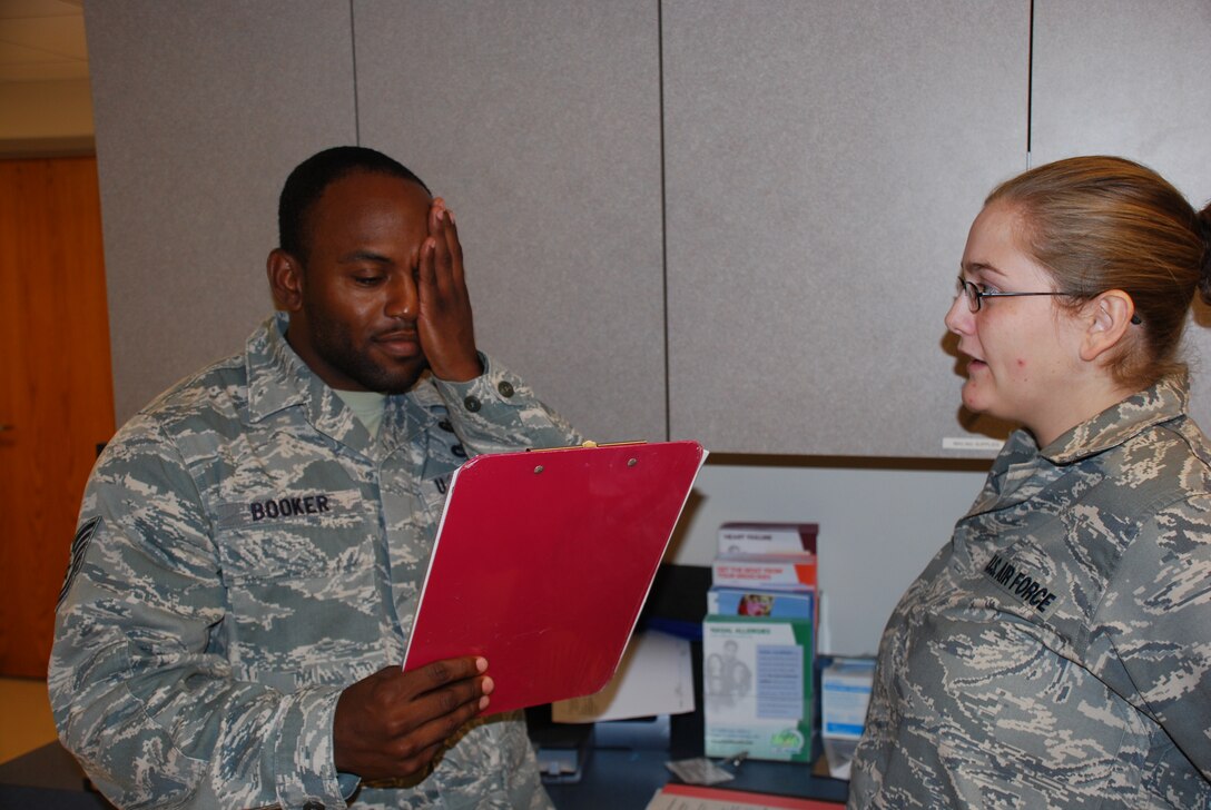 Airman Shawna Martin, 82nd Medical Operations Squadron, administers
an eye test to Tech. Sgt. Andre Booker, 362nd Training Squadron.  On June 20
and 21, eye tests were given to over 250 permanent party Airmen as part of
the "Preventive Health Assessment and Individual Medical Readiness"
screening ensuring they are medically prepared for deployment.(U.S. Air Force photo/Mike McKito)
