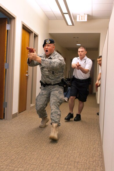 HANSCOM AIR FORCE BASE, Mass. - Senior Airman Nicholas Witters leads Airman 1st Class Rent Seebeck and Airman 1st Class Andrei Oliynik as they approach a suspect during an active shooter exercise scenario on June 16 in Building 1604. The 66th Security Forces Squadron responded to the active shooter incident as part of the Base Readiness Exercise last week. (U.S. Air Force photo by Mark Wyatt)