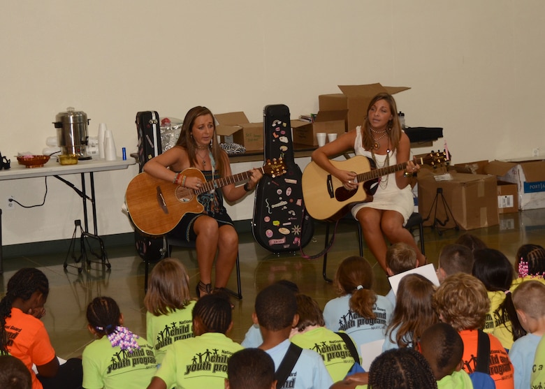 Cassy and Alyssa Gaddis perform their song, “Sticks and Stones”, for the campers at the Homefront Challenge Camp.  The Homefront Challenge is a week-long camp for children who have parents or guardians serving in the Maryland Army or Air Force National Guard.  The Gaddis sisters are a traveling duo that performs for military kids all over the United States.  The Homefront Challenge Camp took place over the week of June 20-24 at Rock State Park in Jarrettsville, Maryland.