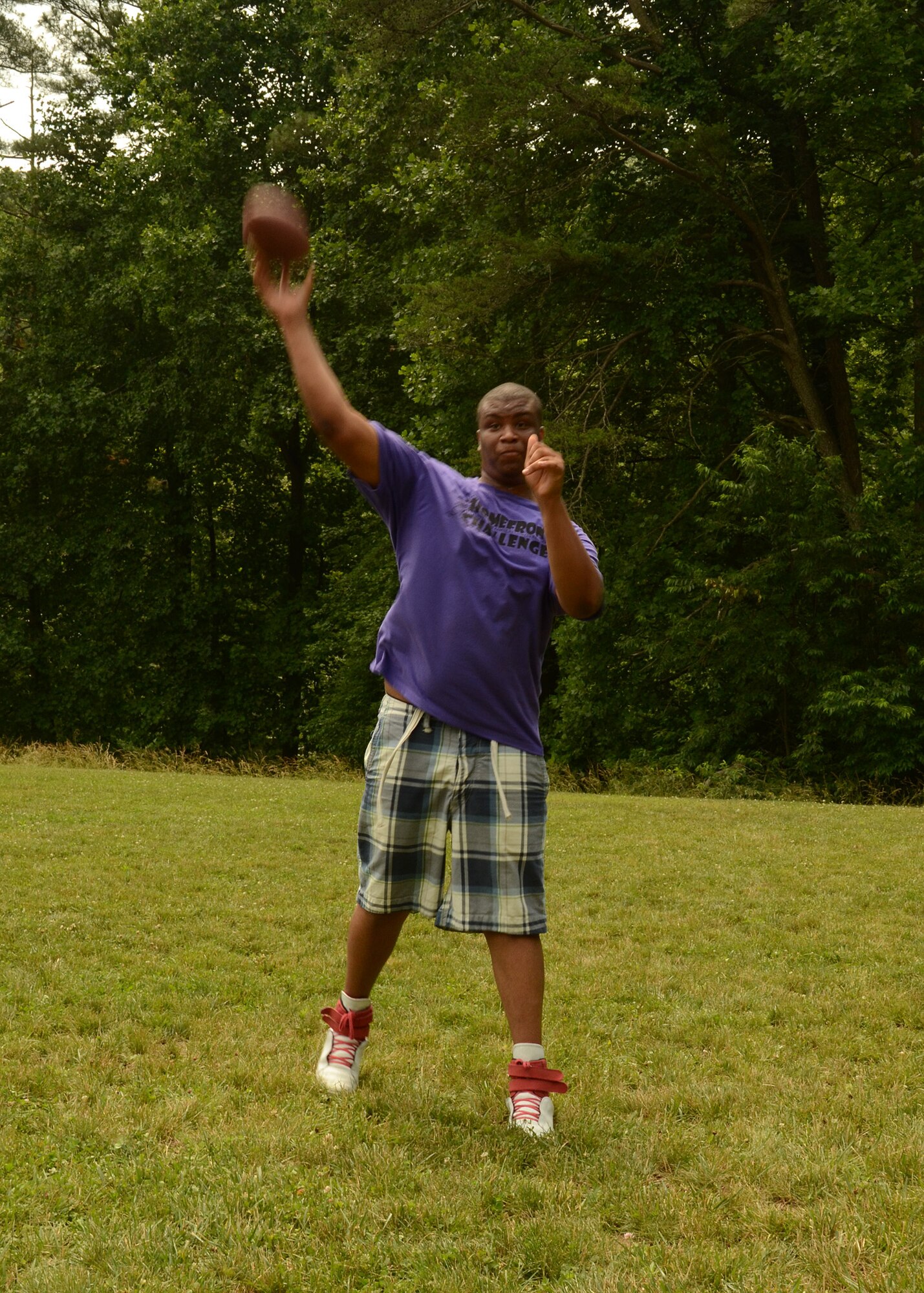 Chance Lane, junior counselor at the Homefront Challenge Camp launches a pass to another campers during a friendly flag football game.  The Homefront Challenge is a week-long camp for children who have parents or guardians serving in the Maryland Army or Air Force National Guard.  The campers have the opportunity to participate in many different activities including flag football, kickball and archery.  The Homefront Challenge Camp took place over the week of June 20-24 at Rock State Park in Jarrettsville, Maryland. 