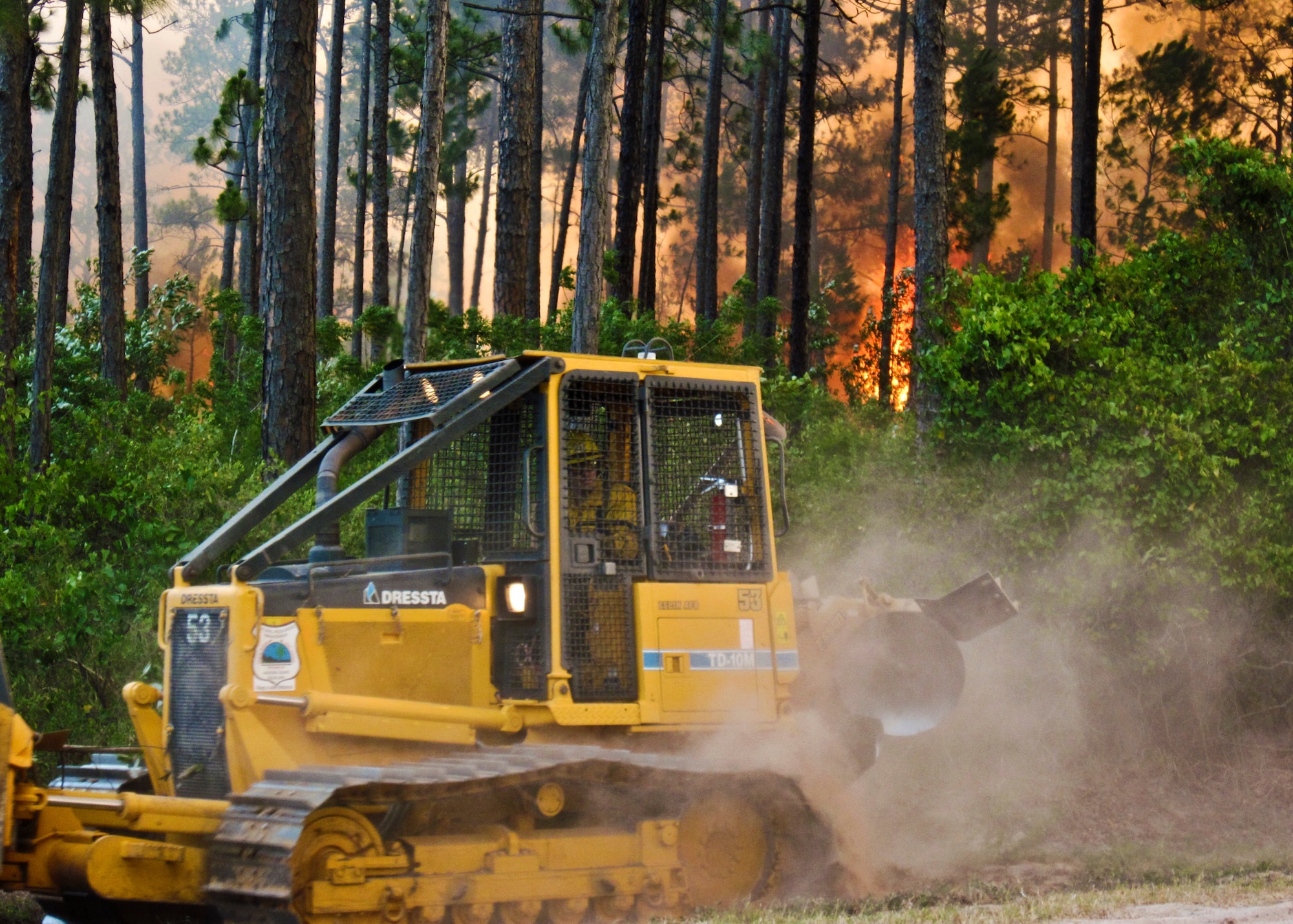 Firefighters from Eglin Fire Department and Jackson Guard work with the Ocean City/Wright and Fort Walton Beach Fire Departments to contain two urban-interface wildfires within the same vicinity on Eglin reservation, June 22.  Northwest Florida is in the midst of a severe drought and is 15 inches below normal rainfall for the year.  The wildfires burned more than 15 acres of forest and threatened homes and businesses, but due to firefighting efforts no structures were damaged.  (U.S. Air Force photo/Mike Spaits)