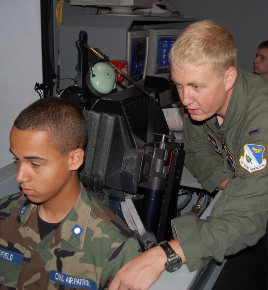 LAUGHLIN AIR FORCE BASE, Texas - - First Lt. Brian Crum, 47th Operations Support Squadron, guides Parker Merrifield, a Civil Air Patrol cadet, through a T-6 simulator ride here June 21. The CAP cadets spent a week at Laughlin learning about various aspects of the 47th Flying Training Wing mission. (U.S. Air Force photo by Laura Salazar)