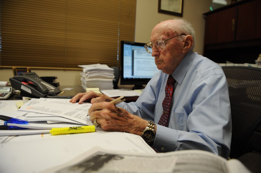 William Banks, 7th Contracting Squadron director of business, signs paperwork June 23, 2011 at his desk here. After 67 years of faithful service, Dyess prepares to bid farewell to Mr. Banks, who is scheduled to retire June 30, 2011 at the Hangar Center. (U.S. Air Force photo by Airman 1st Class Jonathan Stefanko/Released)