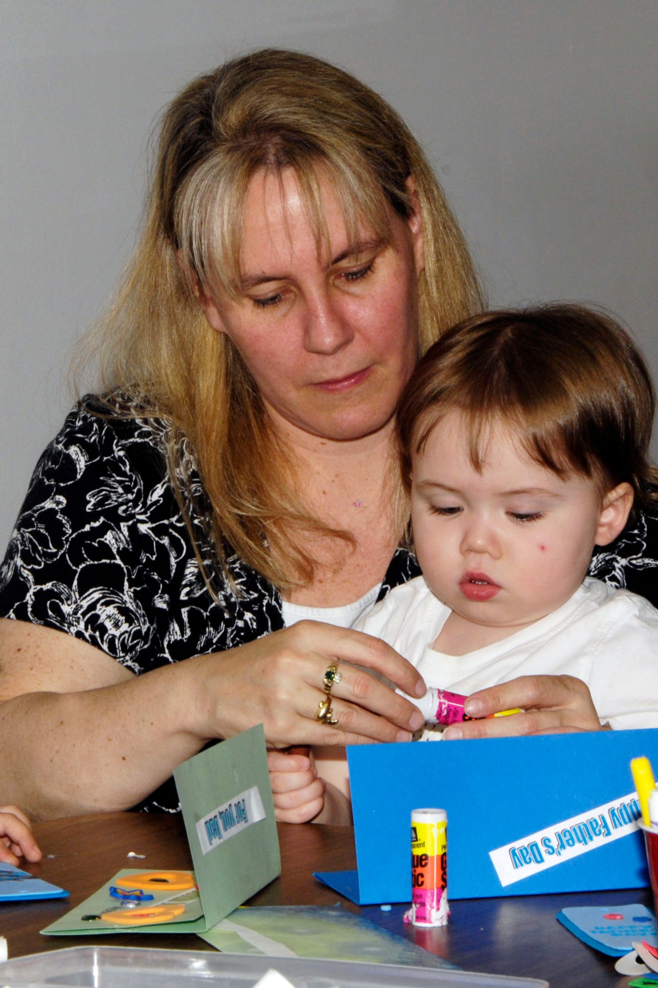 HANSCOM AIR FORCE BASE, Mass. – Stephen Lutjen, with the assistance of his mother, makes a Father’s Day card at the Base Library June 16. Children were invited to the library to listen to a story and then make a card or craft during this special event. (U.S. Air Force photo by Linda LaBonte Britt)