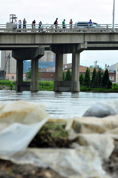 MINOT AIR FORCE BASE, N.D. – The citizens of Minot look on as the Souris River is wells in size, breaching dikes built to contain the water here June 22. By June 29, 2011, Mouse River pressures and heights will reach unprecedented levels—seven to ten feet higher than the all time record with pressures reaching approximately 16,000 cubic feet per second. On June 22, 2011 the river, breached the levees and the warning sirens sounded requiring the immediate evacuation of over 11,000 Minot residents to include nearly 1,000 Air Force Global Strike Command Airmen. (U.S. Air Force photo/Senior Airman Jesse Lopez)