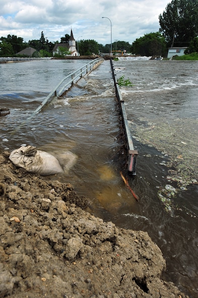 MINOT AIR FORCE BASE, N.D. -- The Souris River is welling in size and breaching dikes built to contain the water here June 22. By June 29, 2011, Mouse River pressures and heights will reach unprecedented levels—seven to ten feet higher than the all time record with pressures reaching approximately 16,000 cubic feet per second. On June 22, 2011 the river, breached the levees and the warning sirens sounded requiring the immediate evacuation of over 11,000 Minot residents to include nearly 1,000 Air Force Global Strike Command Airmen. (U.S. Air Force photo/Senior Airman Jesse Lopez)