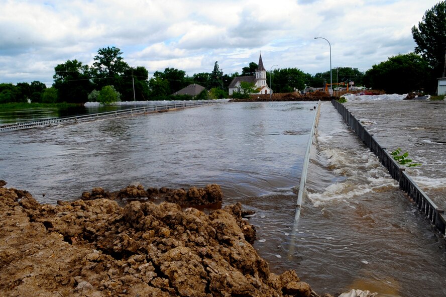 MINOT AIR FORCE BASE, N.D. -- The Souris River is swelling in size and breaching dikes built to contain the water here June 22.  By  June 29, 2011, Mouse River pressures and heights will reach unprecedented levels—seven to ten feet higher than the all time record with pressures reaching approximately 16,000 cubic feet per second. On June 22, 2011 the river, breached the levees and the warning sirens sounded requiring the immediate evacuation of over 11,000 Minot residents to include nearly 1,000 Minot Air 
Force Global Strike Command Airmen.. (U.S. Air Force photo/Senior Airman Aaron-Forrest Wainwright)
