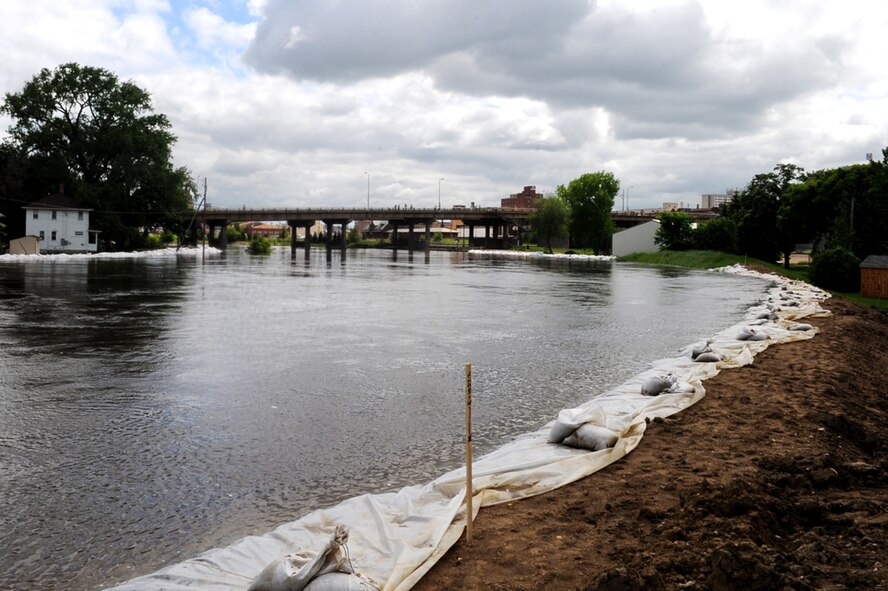 MINOT AIR FORCE BASE, N.D. -- The Souris River is swelling in size and breaching dikes built to contain the water here June 22.  By  June 29, 2011, Mouse River pressures and heights will reach unprecedented levels—seven to ten feet higher than the all time record with pressures reaching approximately 16,000 cubic feet per second. On June 22, 2011 the river, breached the levees and the warning sirens sounded requiring the immediate evacuation of over 11,000 Minot residents to include nearly 1,000 Minot Air 
Force Global Strike Command Airmen.. (U.S. Air Force photo/Senior Airman Aaron-Forrest Wainwright)
