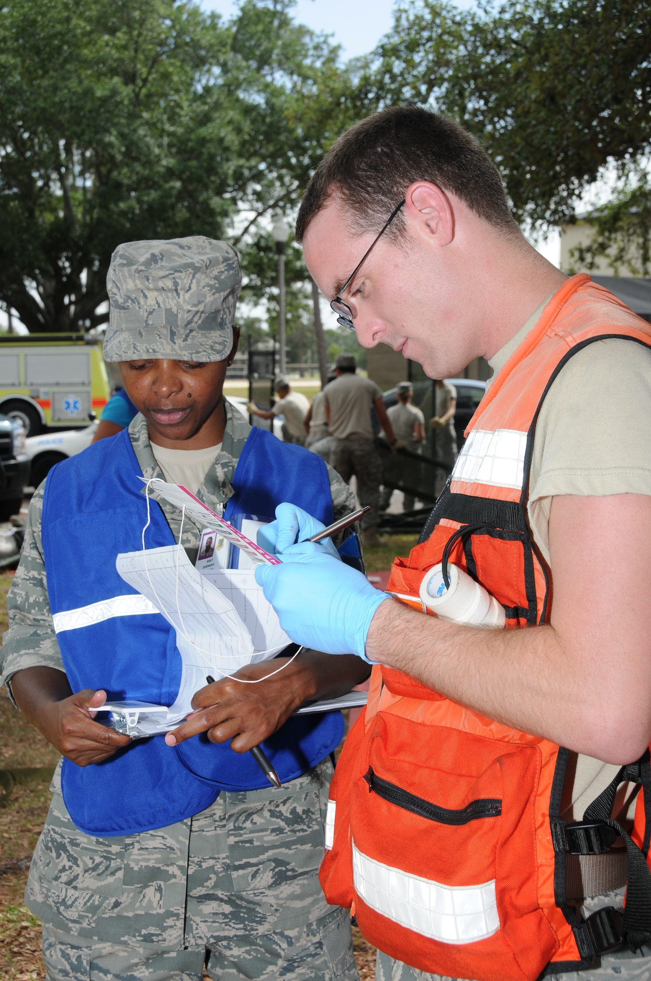 Staff Sgt. Jermeka Howard, left, a member of Keesler's exercise evaluation team from the 81st Medical Group, takes notes as Senior Airman Colin Guzak, 81st Aerospace Medicine Squadron, records the status of "victims" on tags during Keesler's active shooter exercise, June 21-22.  Sergeant Gerlich portrayed the lone gunman who opened fire at Airman Leadership School, with 12 people killed and 17 injured.  The exercise, conducted by Air Education and Training Command, tested the base's ability to respond and recover from a mass casualty event.    (U.S. Air Force photo by Kemberly Groue)