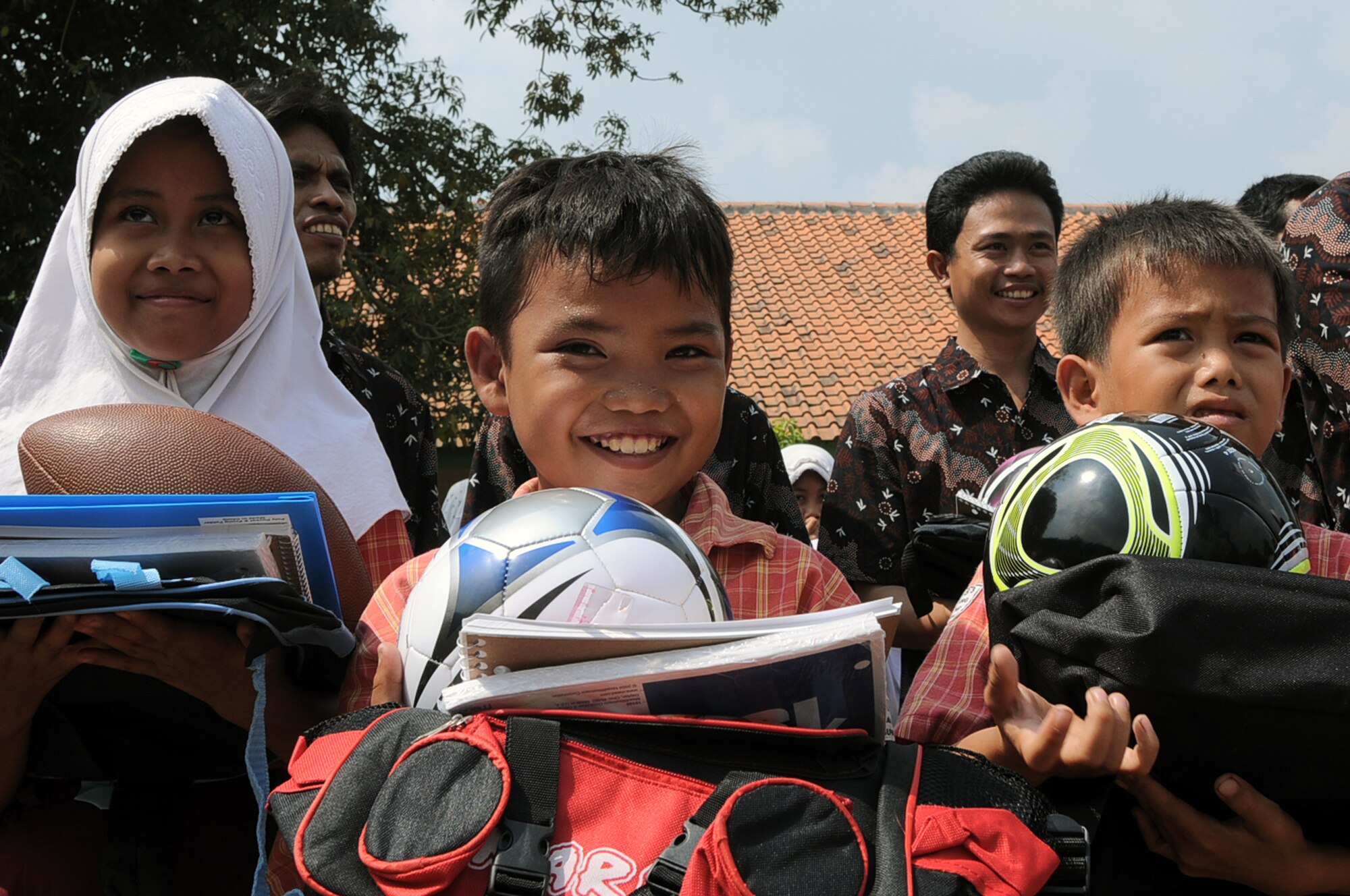 BINGUANG DISTRICT, Indonesia -- Indonesian schoolchildren from the Negri Warakas No. 3 Elementary School receive free school supplies and sports equipment donated by Airmen from Yokota Air Base, Japan during a goodwill visit in Binguang district, Indonesia, June 23, 2011. Visiting local Indonesian schools has become tradition for Yokota's Cope West teams, with Airmen gathering donations from the base community prior to departing from their home station. (U.S. Air Force photo/Capt. Raymond Geoffroy)
