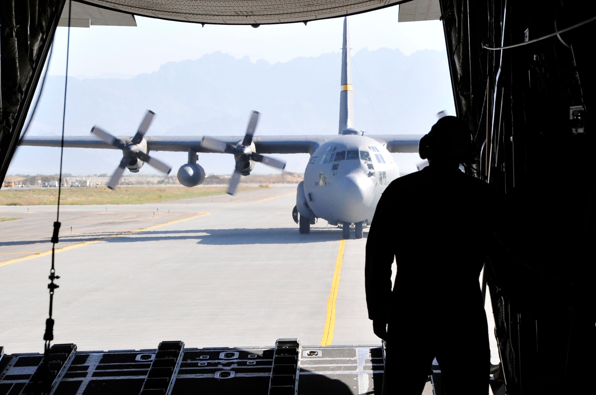 BAGRAM AIRFIELD, Afghanistan -- Master Sgt. Timothy Griffin, a C-130 Hercules loadmaster with the New York Air National Guard, lowers the aircraft ramp after returning here from a formation airdrop to a forward operating base in Oruzgan Province, Afghanistan, June 22. The New York ANG C-130 flew the airdrop mission in conjunction with another C-130 from the Alaska ANG. Airdrops help mitigate the danger of transporting supplies via convoy. (U.S. Air Force photo by Capt. Korry Leverett)