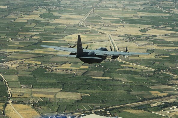 A C-130 Hercules from the New York Air National Guard and deployed with the 774th Expeditionary Airlift Squadron at Bagram Airfield, Afghanistan, flies over Afghan landscape on its way to delivering much-needed supplies to a forward operating base in Oruzgan Province, Afghanistan, on June 22, 2011. The New York ANG C-130 flew the airdrop mission in conjunction with another C-130 from the Alaska ANG. Officials say airdrops help mitigate the danger of transporting supplies via convoy. (U.S. Air Force Photo/Senior Airman Krista Rose)