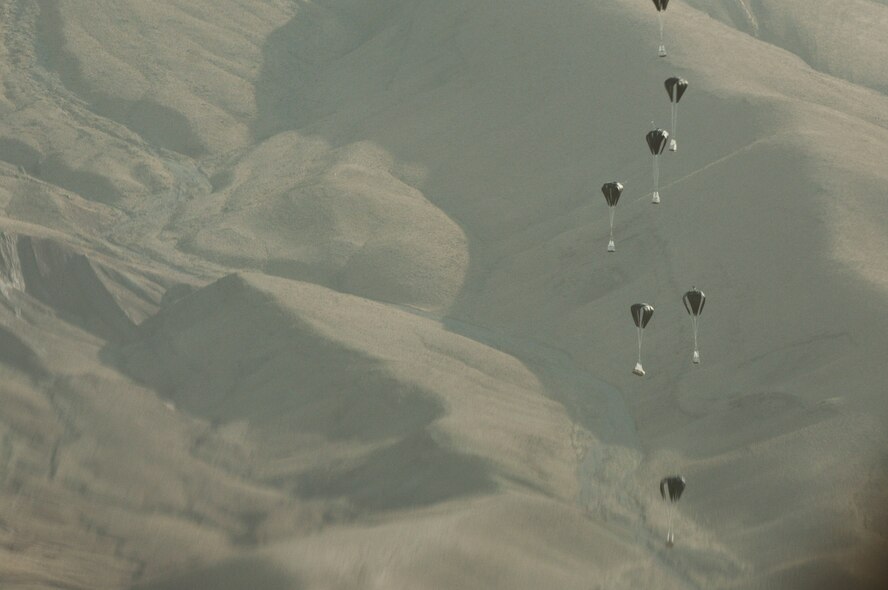Pallets of much-needed supplies parachute down to a forward operating base in Oruzgan Province, Afghanistan, on June 22, 2011. Two C-130 Hercules aircraft, one from the Alaska Air National Guard and one from the New York Air National Guard and both deployed with the 774th Expeditionary Airlift Squadron at Bagram Airfield, Afghanistan, performed the joint airdrop. Officials say airdrops help mitigate the danger of transporting supplies via convoy. (U.S. Air Force Photo/Senior Airman Krista Rose)
