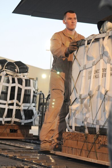 Airman 1st Class Connor Murray, 774th Expeditionary Airlift Squadron C-130 Hercules aircraft loadmaster, at Bagram Airfield, Afghanistan, loads a pallet on to a C-130 destined for a forward operating base in Oruzgan Province, Afghanistan, on June 22, 2011. Officials say airdrops help mitigate the danger of transporting supplies via convoy. Airman Murray, a Wasilla, Alaska, native, is a member of the Alaska Air National Guard stationed at Joint Base Elmendorf-Richardson, Alaska. (U.S. Air Force Photo/Senior Airman Krista Rose) 