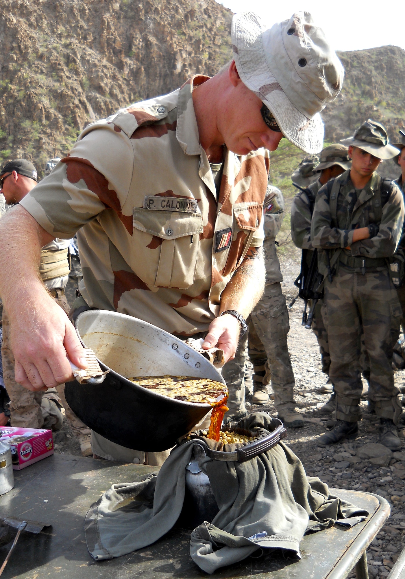 GOUBETTO, Djibouti – A French Army 5th Marine Regiment Desert Combat Training instructor prepares a pot of tea during a desert combat training course which began May 31, in the Bour Ougoul training area. The 10-day course provided nearly 120 French and 40 U.S. servicemembers with a basic knowledge of field tactics and survival techniques to use within a desert environment. (U.S. Air Force photo by Staff Sgt. R.J. Biermann) 