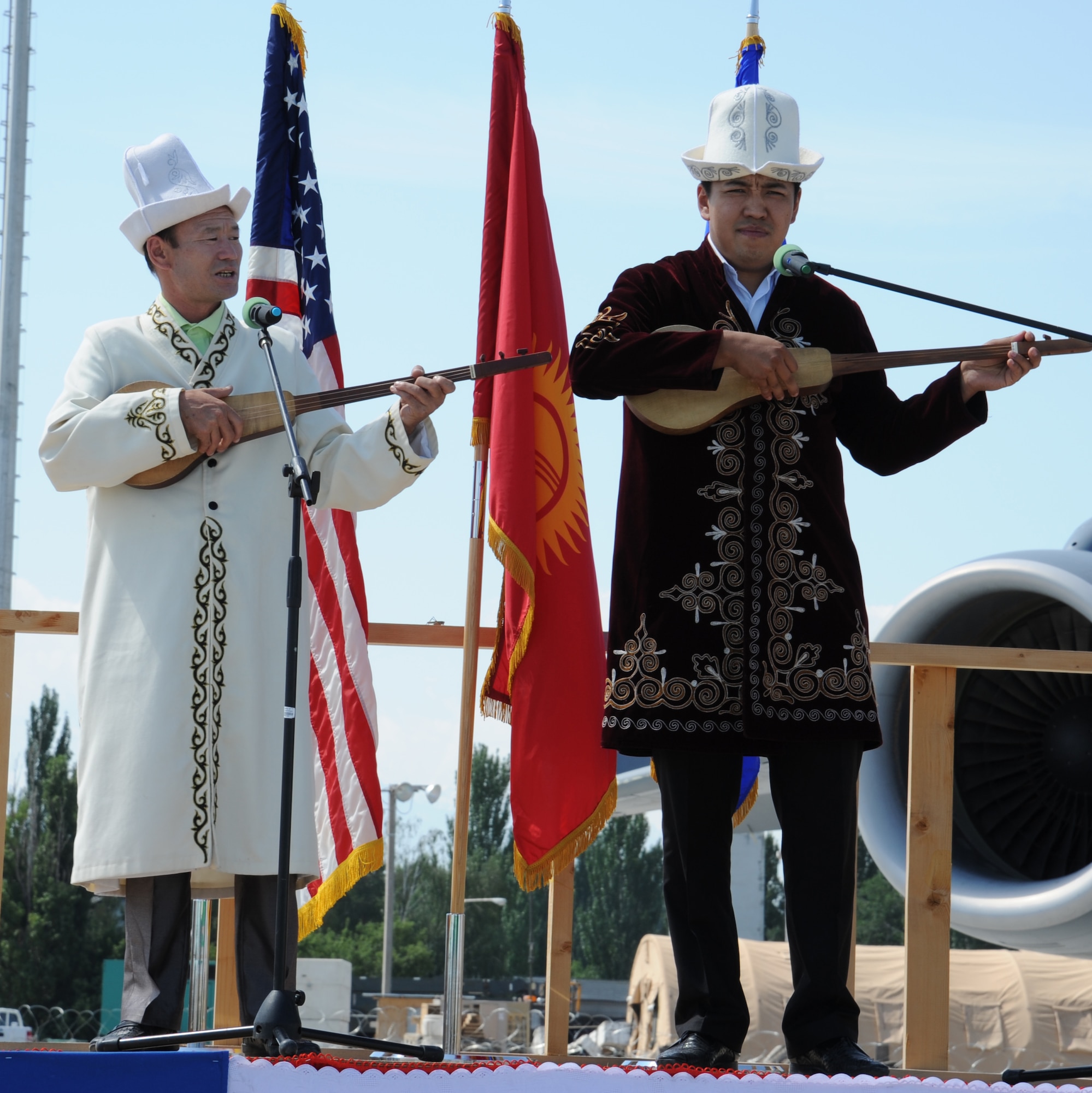 TRANSIT CENTER AT MANAS, Kyrgyzstan – Kyrgyz traditional storytellers and singers improvise a song at the conclusion of the large aircraft ramp dedication ceremony here June 23. The new $30 million ramp increases the Transit Center’s maximum parking capacity by 52 percent. (U.S. Air Force photo by/Tech. Sgt. Hank Hoegen)