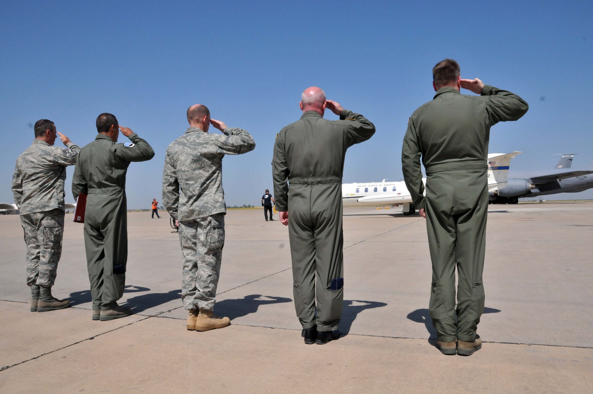 Col. Edward E. Metzgar, 313th Air Expeditionary Wing commander, along with his senior staff members render hand salute as Maj. Gen. Margaret H. Woodward, Commander, 17th Air Force (U.S. Air Forces Africa) arrive at an air base in Western Europe on June 21, 2011. (U.S. Air Force photo/Capt. John P. Capra)