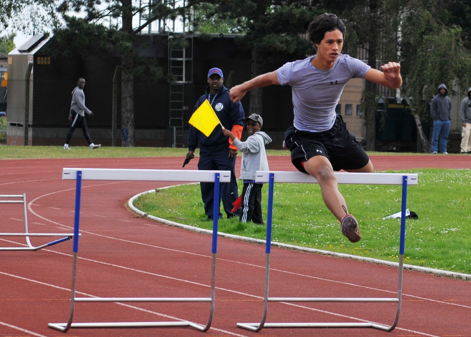 ROYAL AIR FORCE LAKENHEATH, England - Patrick Mismick, Lakenheath High School student, leaps a hurdle during the first ever RAF Lakenheath Relays at the base track, June 18, 2011. The competition included track and field events such as the 100-meter dash, 800-meter relay, shot put and discus throw. The event provided Department of Defense personnel the opportunity to be selected to represent the Air Force at the annual Ramstein Allied Headquarters Command Athletics Championships in Europe. (U.S. Air Force photo/Senior Airman Tiffany M. Deuel)