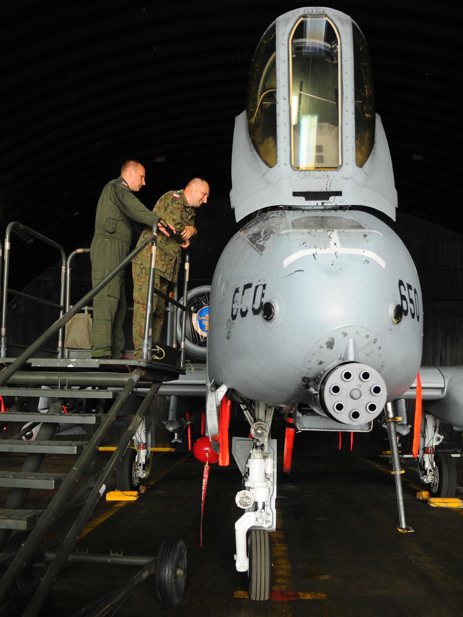 SPANGDAHLEM AIR BASE, Germany – Polish air force 1st Lt. Wolciech Turbak and Polish air force Capt. Tomasz Sekalz peer into the cockpit of an A-10 Thunderbolt II here June 21. Poland’s air force visited the 52nd Fighter Wing to build community relations and learn about the base’s daily flight support operations. (U.S. Air Force photo/Airman 1st Class Dillon Davis)