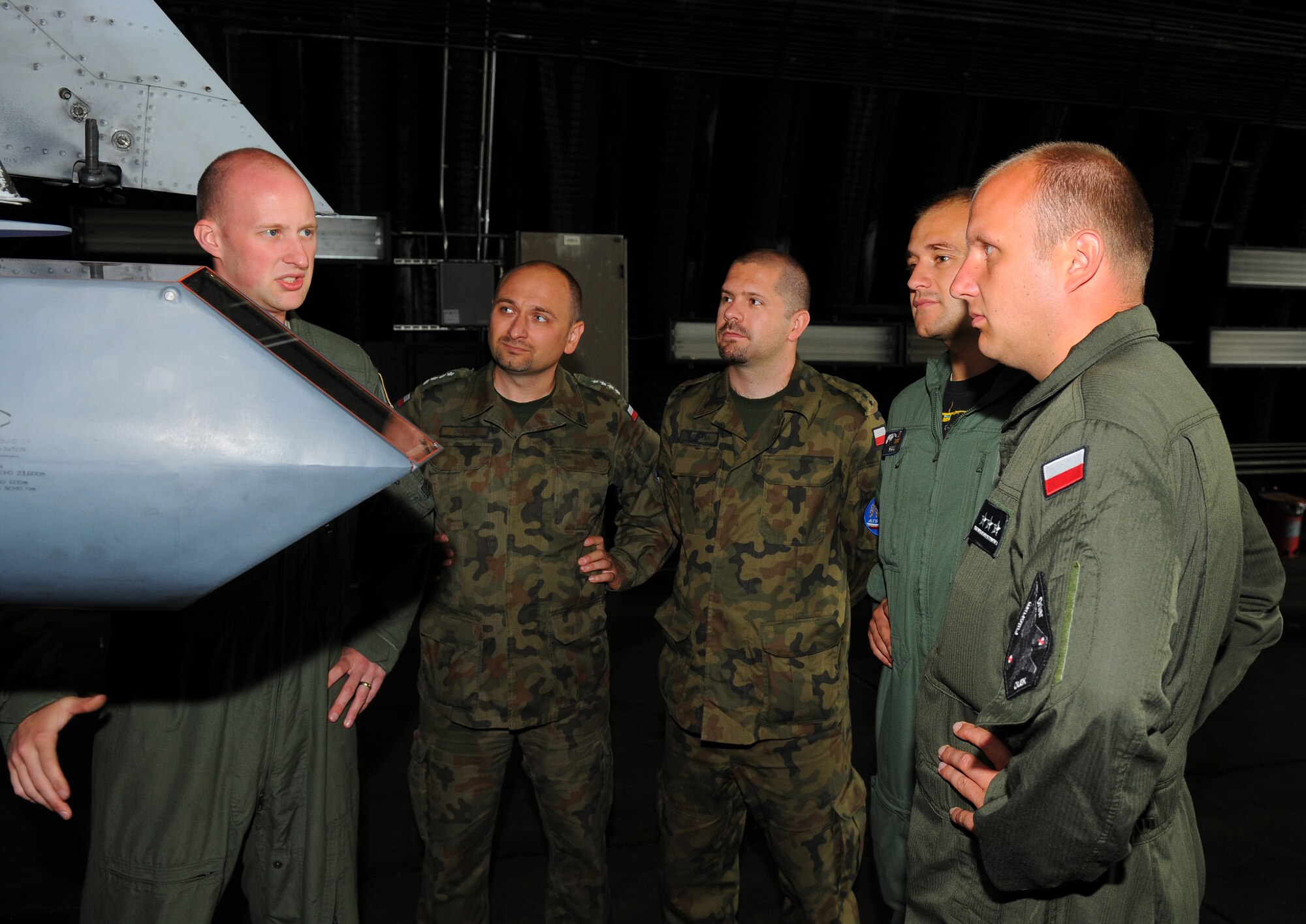 SPANGDAHLEM AIR BASE, Germany – Capt. John Cotman, left, 81st Fighter Squadron A-10 Thunderbolt II pilot, explains the function of the A-10 Thunderbolt II weapon systems to Polish air force visitors here June 21. Poland’s air force visited the 52nd Fighter Wing to build community relations and learn about the base’s daily flight support operations. (U.S. Air Force photo/Airman 1st Class Dillon Davis)