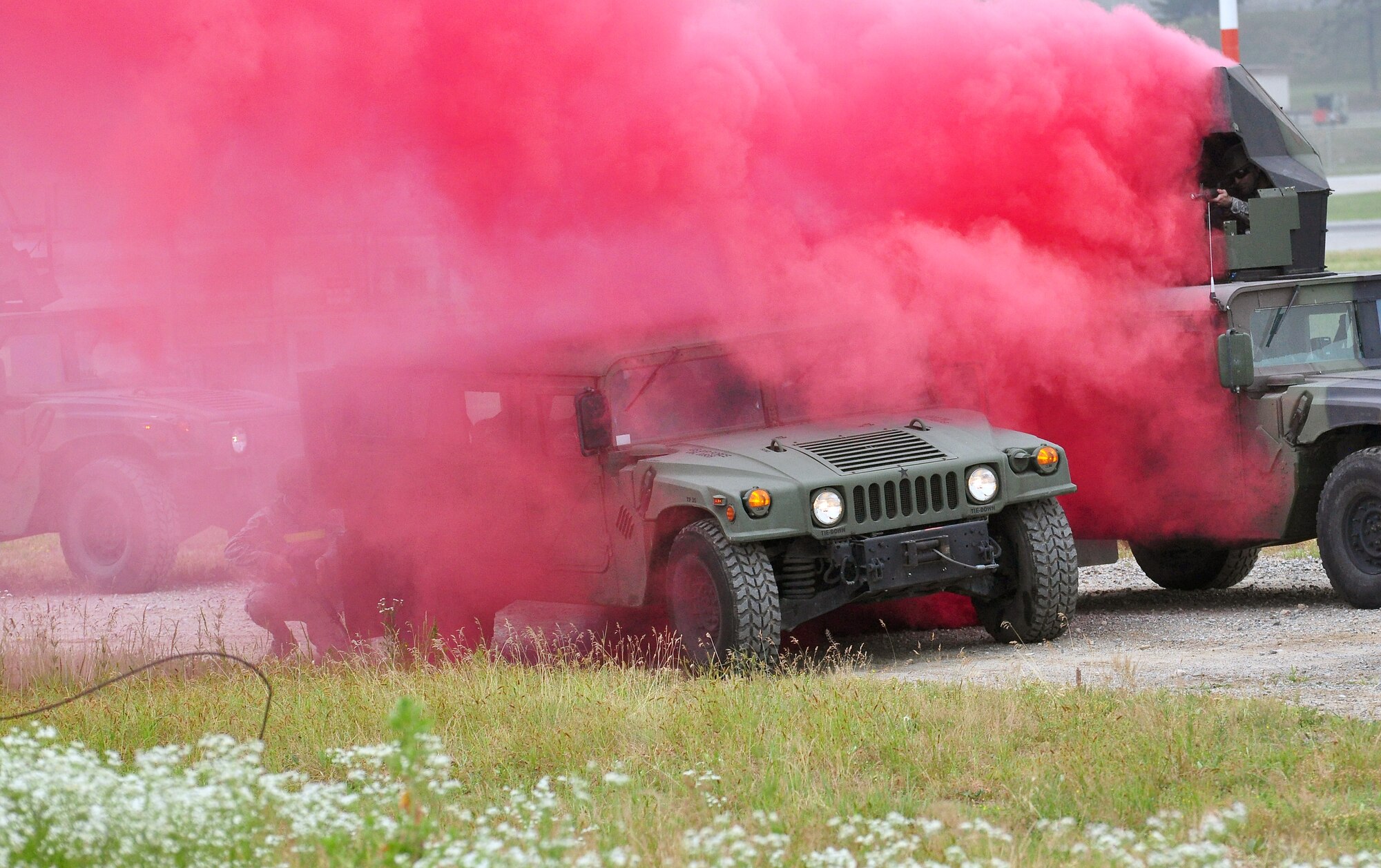 Airmen prepare to enter a functional Humvee after the one they were riding in was hit by a simulated improvised explosive device (IED). Approximately 150 Airmen from the 51st Civil Engineer Squadron participated in PRIME BEEF training June 22 at Osan. Prime BEEF forces have the necessary command, control and communications to support beddown; fire emergency services; emergency management; explosive ordnance disposal; expedient construction; explosive incident response; chemical, biological, radiological and nuclear response and other specialized mission areas. (U.S. Air Force photo/Staff Sgt. Chad Thompson)