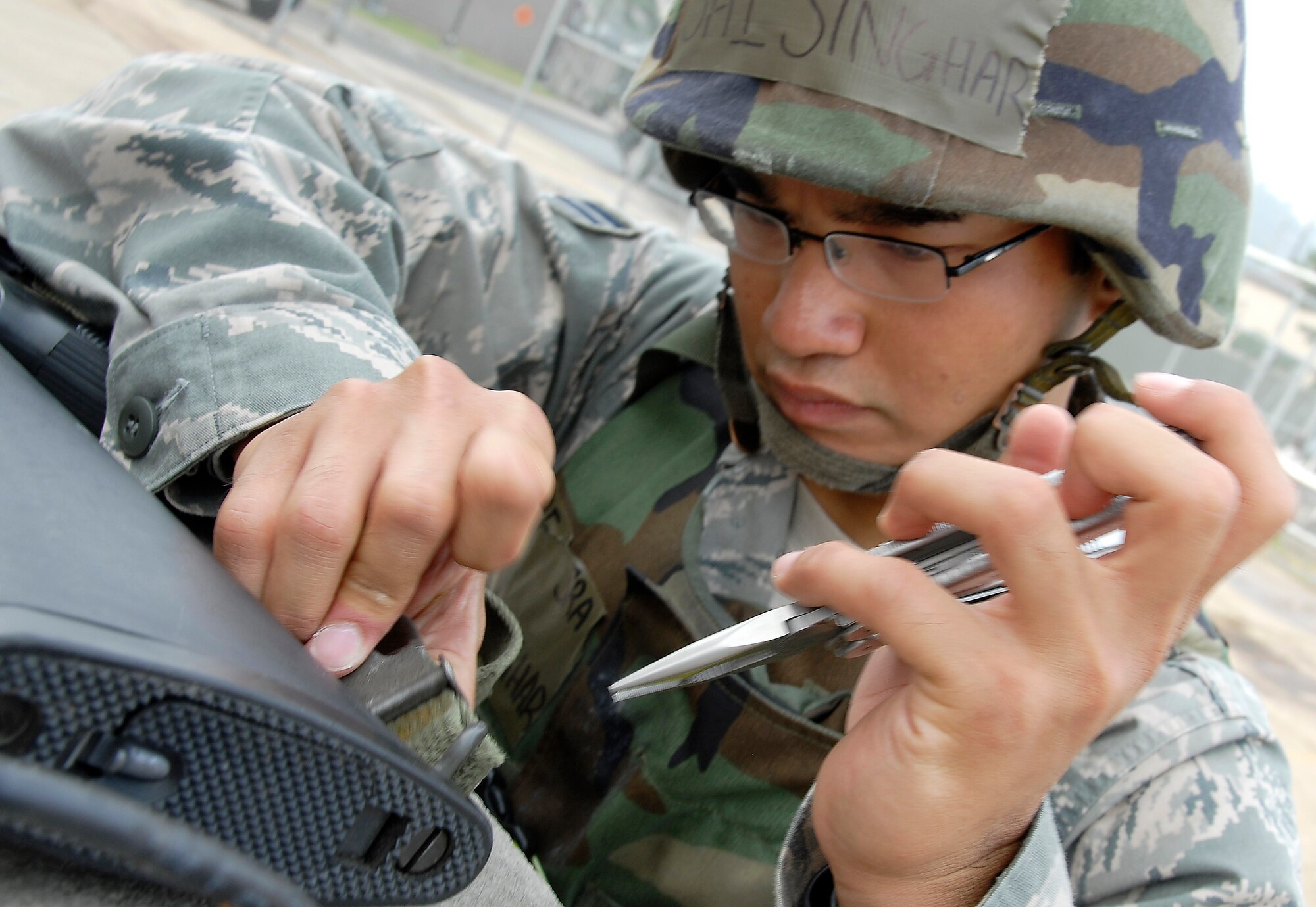 Senior Airman Sai Singhar, an engineering assistant assigned to the 51st Civil Engineer Squadron, Osan Air Base, Republic of Korea, attaches a sling to his M-16 rifle. Airman Singhar and 150 other Airmen from the 51st Civil Engineer Squadron participated in PRIME BEEF training June 22 at Osan. Prime BEEF forces have the necessary command, control and communications to support beddown; fire emergency services; emergency management; explosive ordnance disposal; expedient construction; explosive incident response; chemical, biological, radiological and nuclear response and other specialized mission areas. (U.S. Air Force photo/Senior Master Sgt. Paul Holcomb)